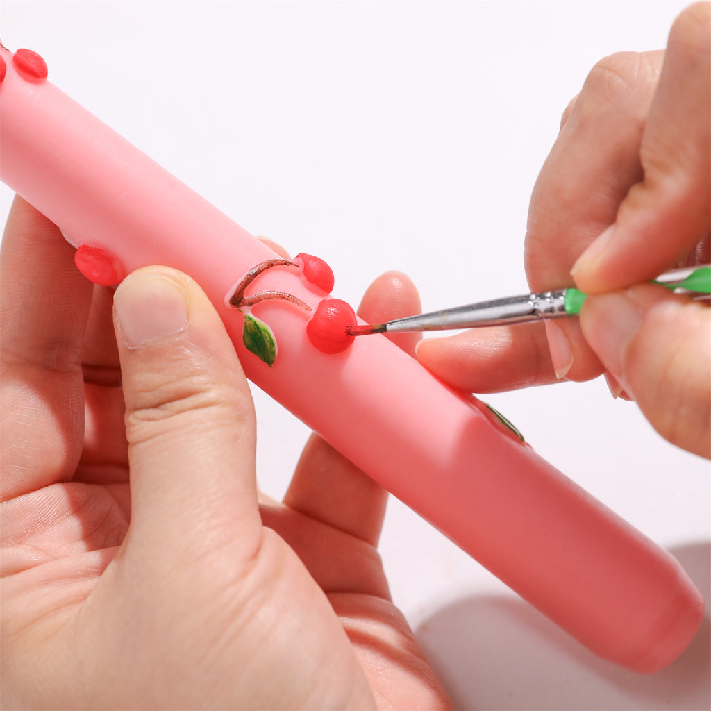 Use colored pencils to color the cherry  taper candle.