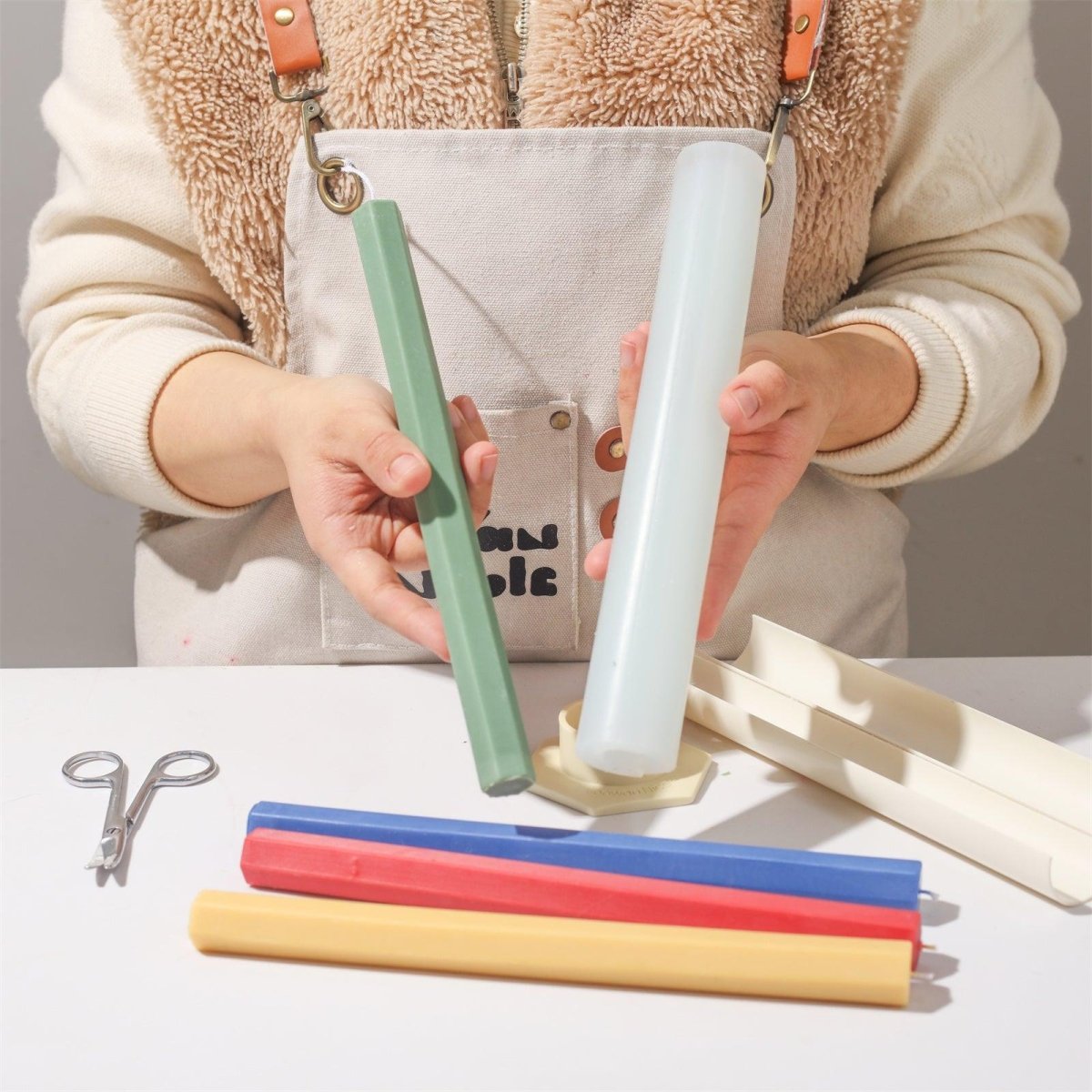 Show the green hexagonal taper candle after being released from the silicone mold-Boowan Nicole