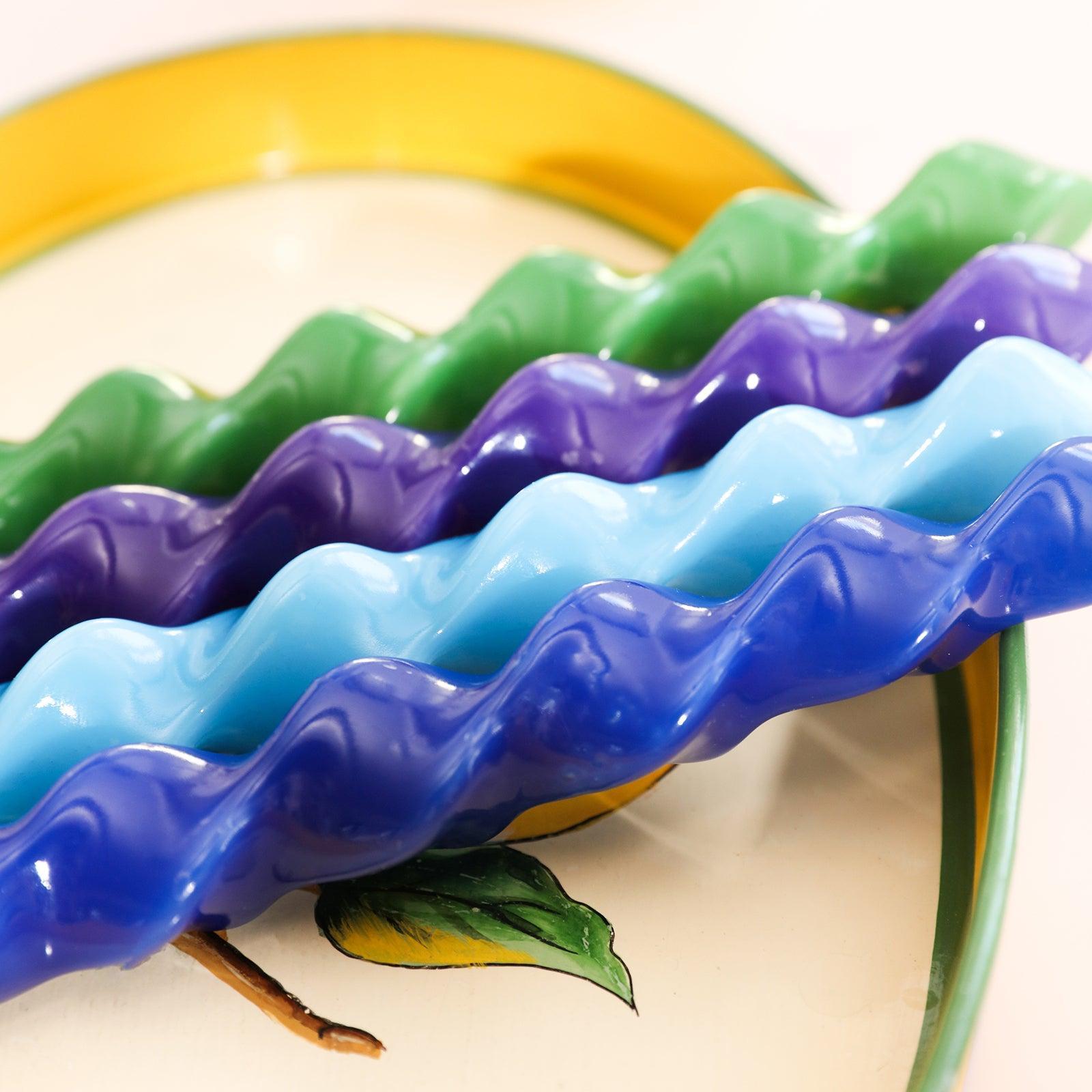 Four Spiral Taper Candles in green, green, blue and purple placed on the tray-Boowan Nicole