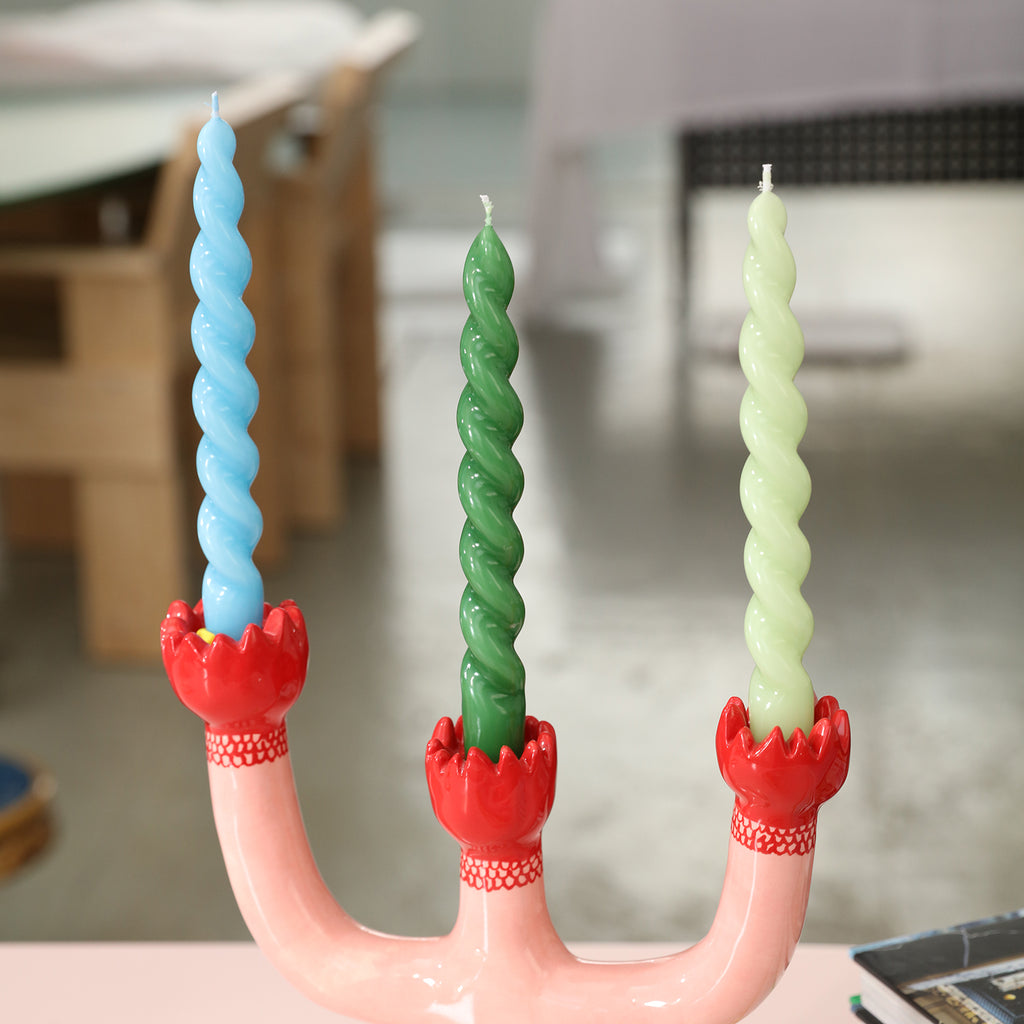 Three smooth tapered spiral candles placed on candlesticks - Boowan Nicole