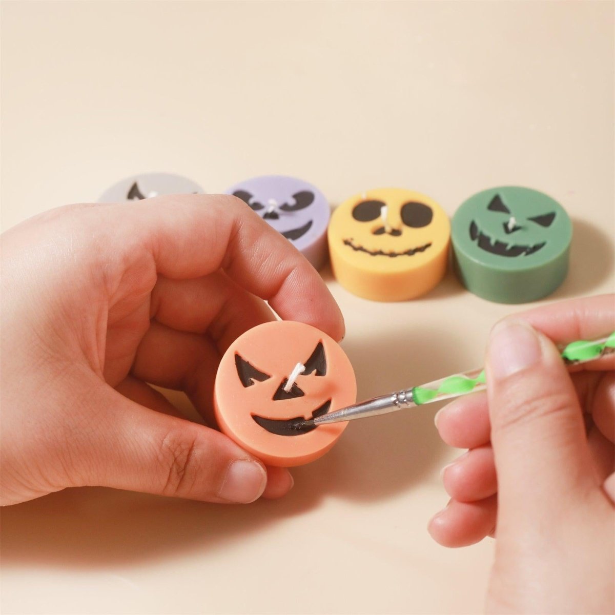 Hand-drawing expressions on tea light candles with a pen, enjoying the fun of crafting - Boowan Nicole