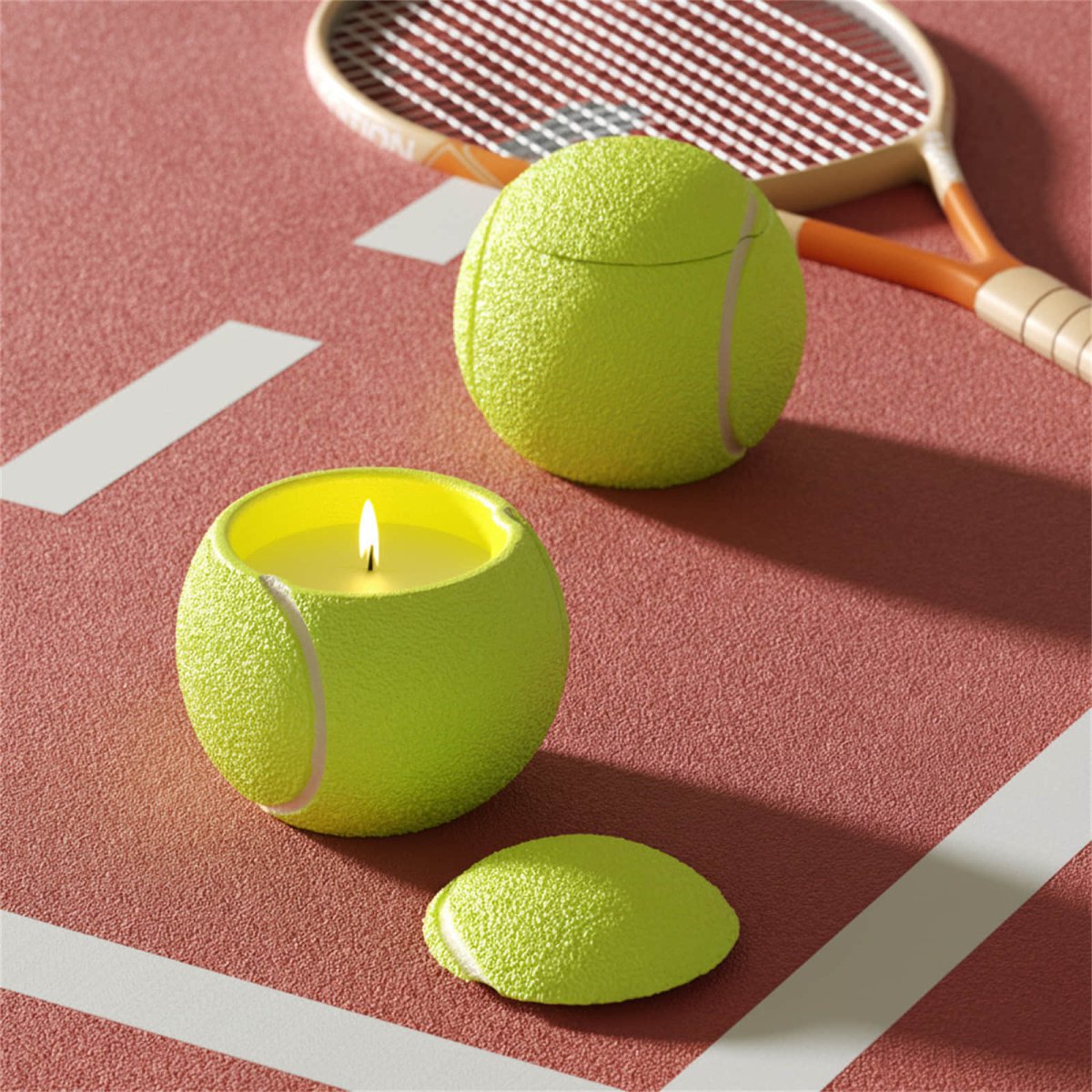 Neon-yellow tennis ball candle jars on a court—one lit, textured pebble surface with white seams, lid nearby, racket in background - Boowan Nicole