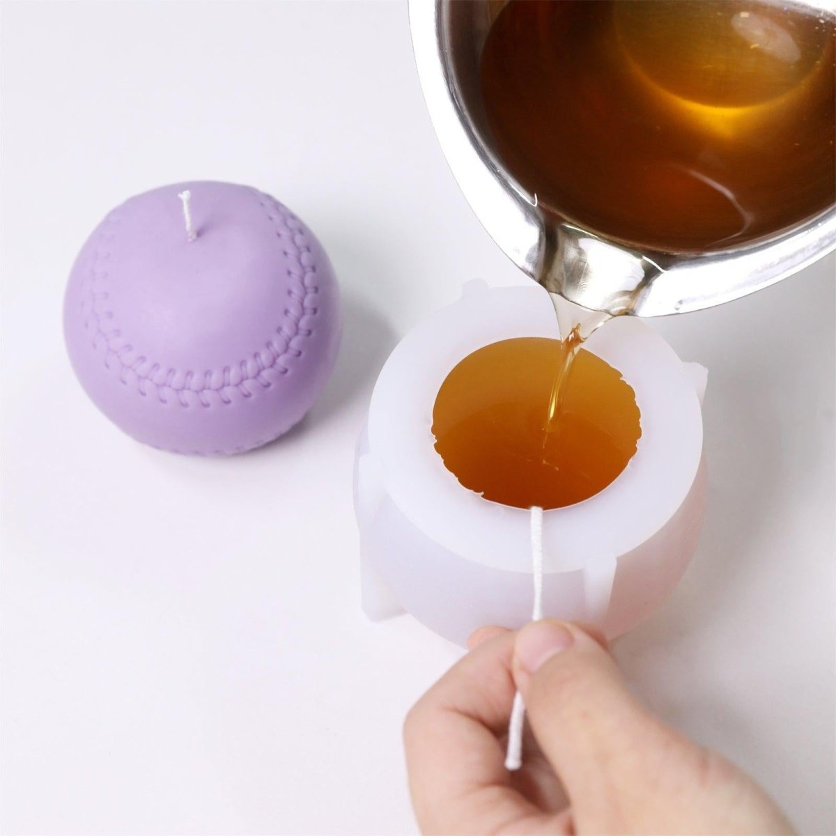 pouring wax into the baseball candle molds