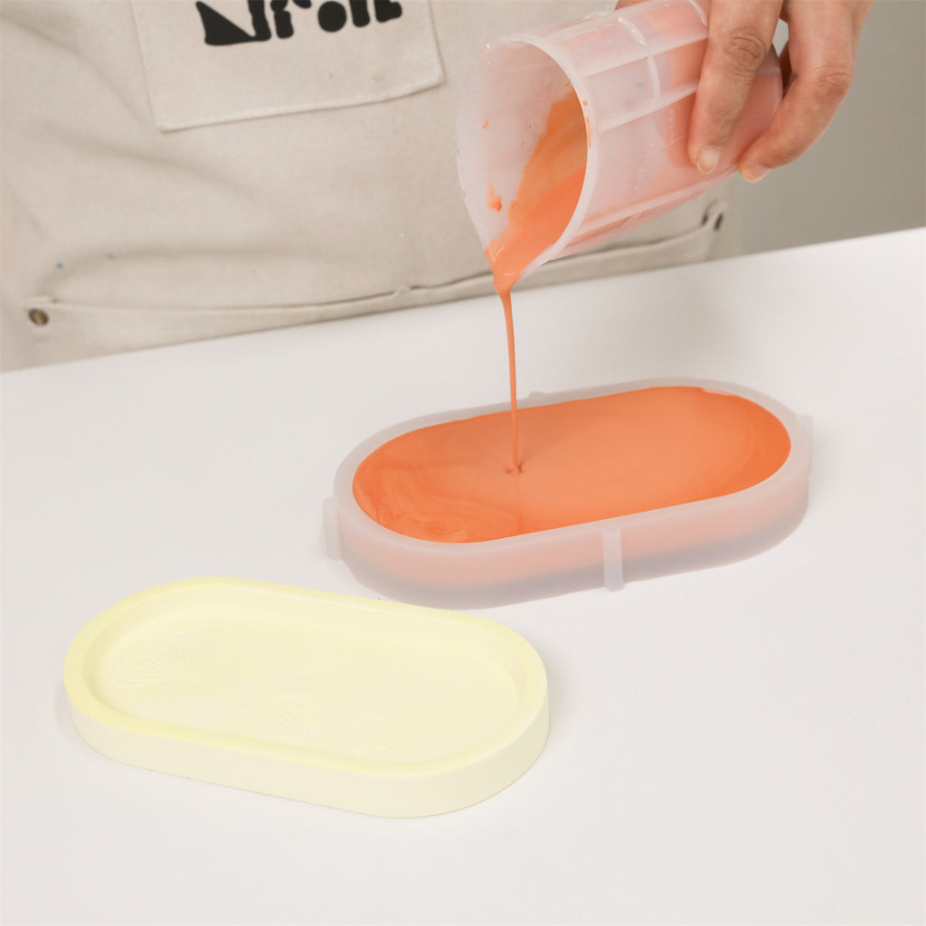 Pouring orange liquid into the silicone tray mold-Boowan Nicole