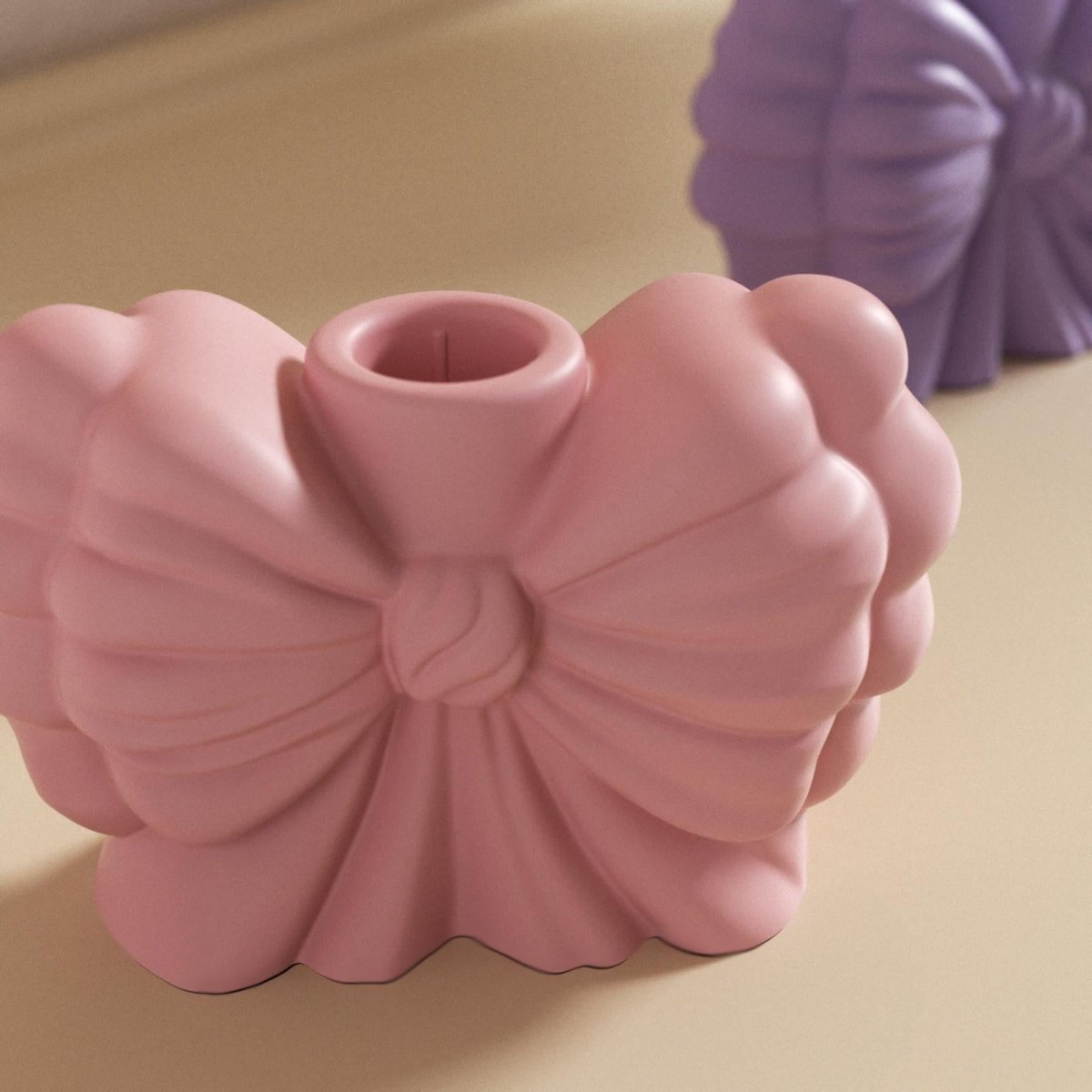 Close-up of pink bow-shaped candle holder with smooth matte finish – decorative handmade home decor - Boowan Nicole