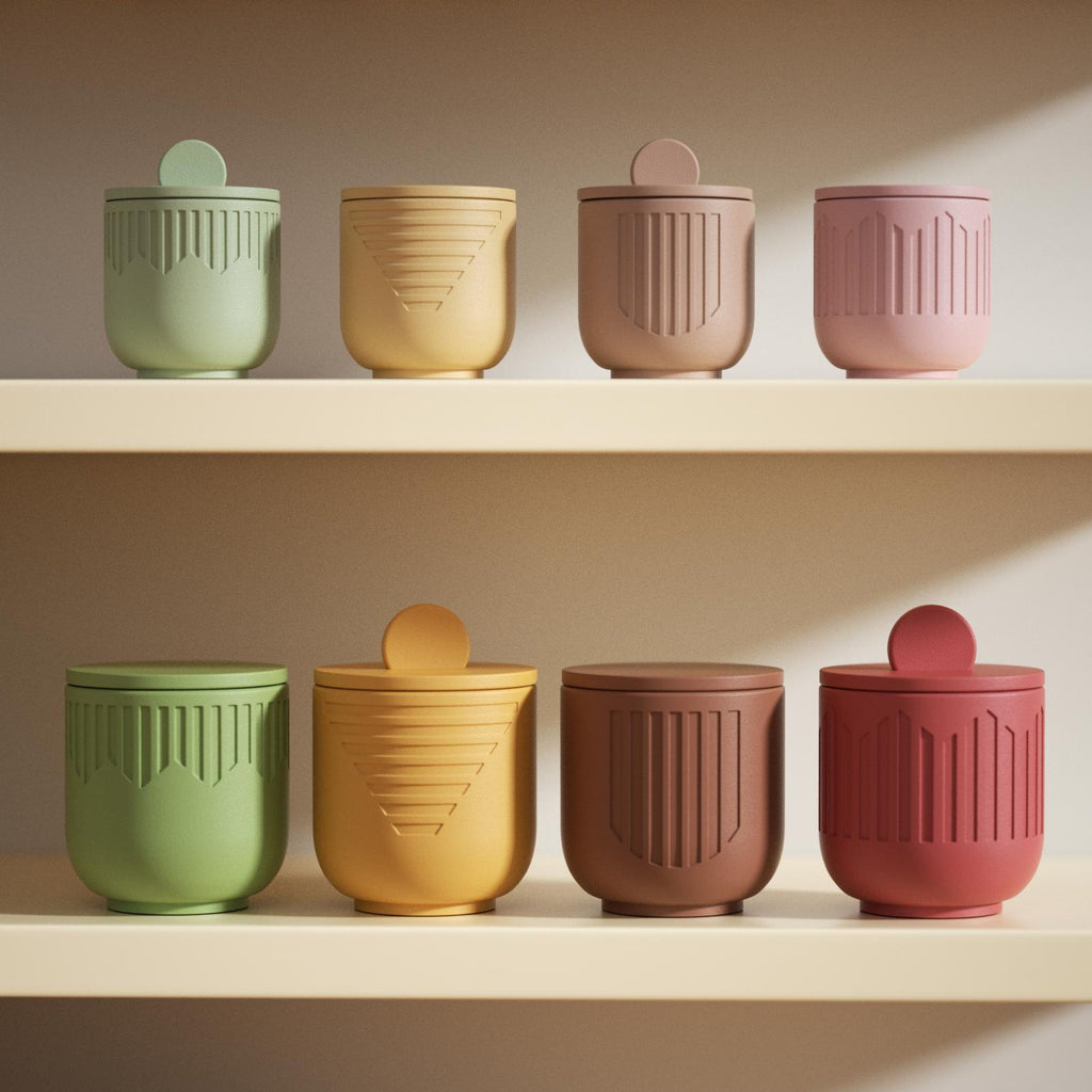Colorful geometric candle jars with lids, in green, yellow, brown, pink, and red, arranged on cream shelves - Boowan Nicole