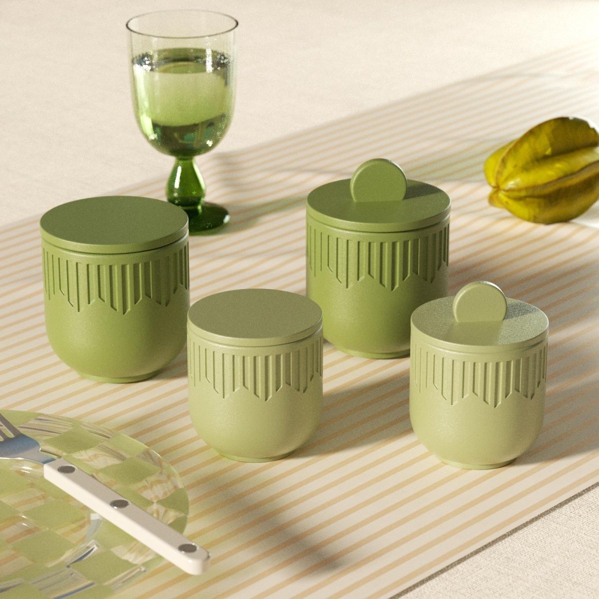Four green geometric candle jars with lids styled on a striped tablecloth with glassware - Boowan Nicole