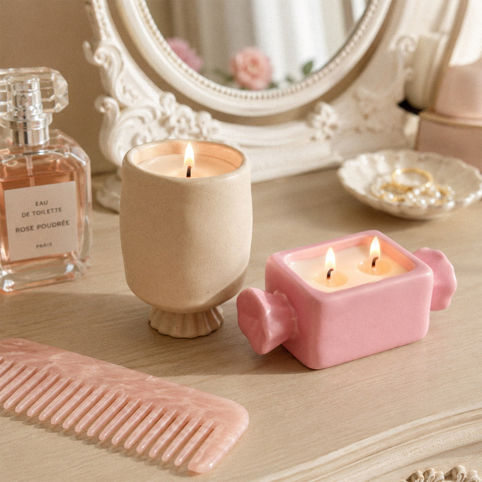 Two styles wrapped bonbon candle jars, beige tall candy vessel and pink rectangular bonbon candle container arranged on light wood vanity table, elegant bedroom decor - Boowan Nicole