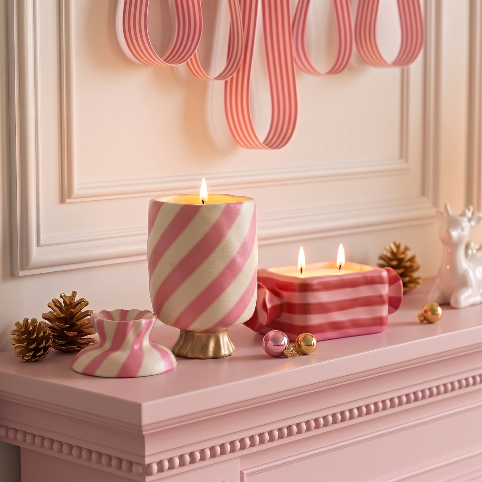 Lit striped wrapped bonbon candle jars placed on pink mantel with pine cones festive home decor styling - Boowan Nicole
