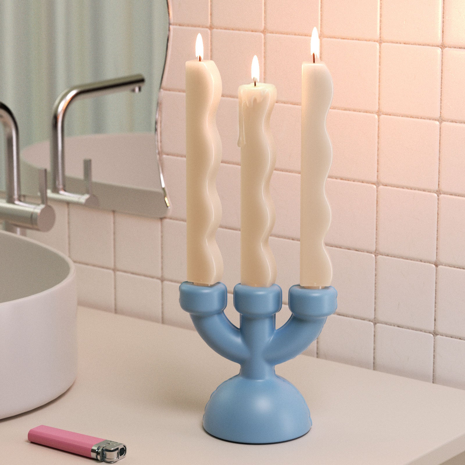 Three wavy zigzag taper candles in a blue candle holder, modern decorative candles burning in a bathroom setting - Boowan Nicole