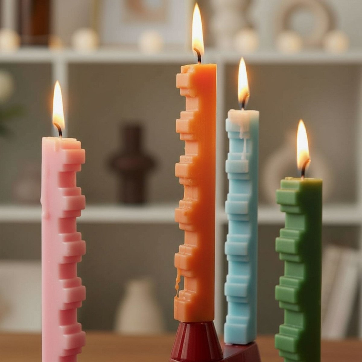 Modern stair-step taper candles burning—geometric sculptural tapers for home décor and DIY candle making, pink orange blue green - Boowan Nicole