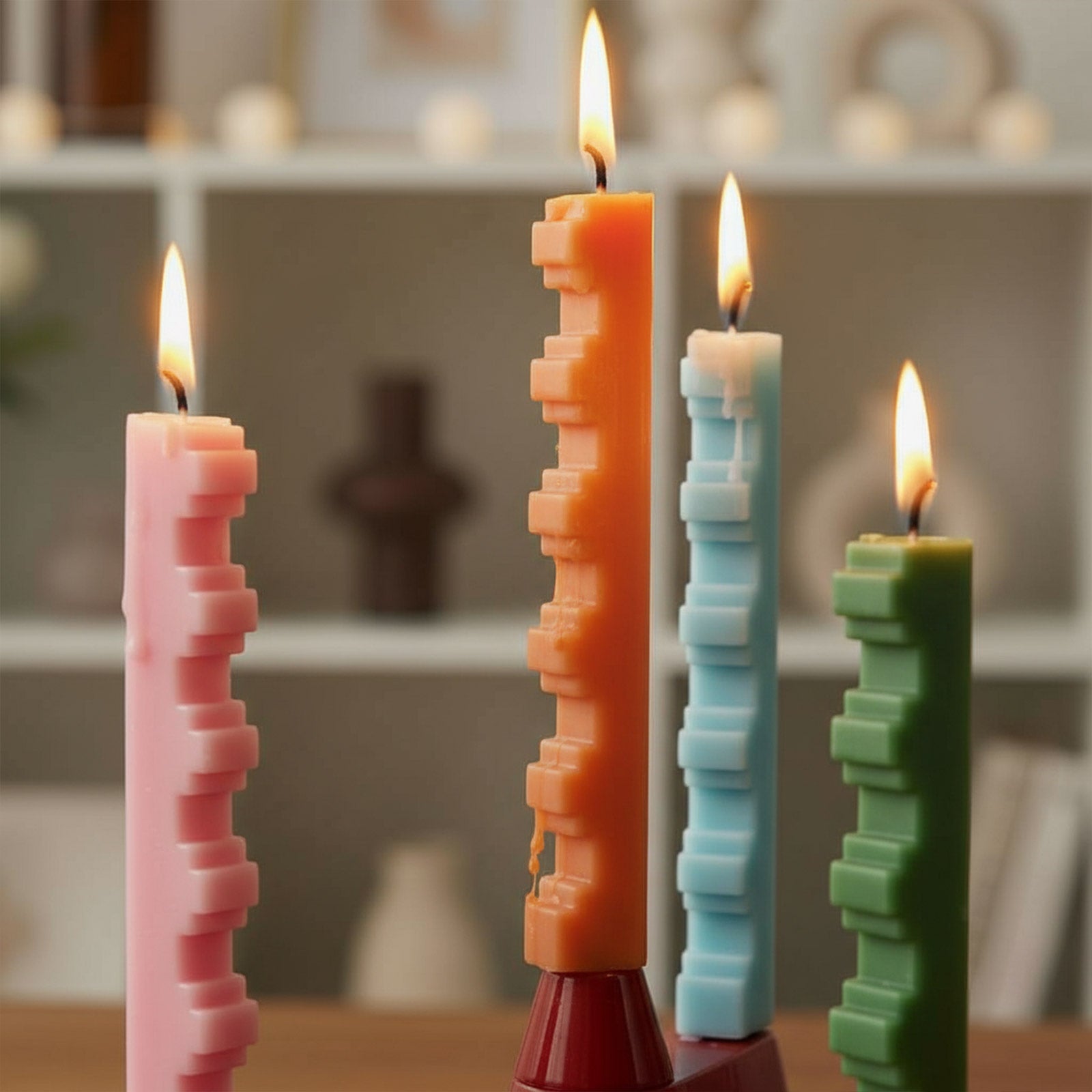 Modern stair-step taper candles burning—geometric sculptural tapers for home décor and DIY candle making, pink orange blue green - Boowan Nicole
