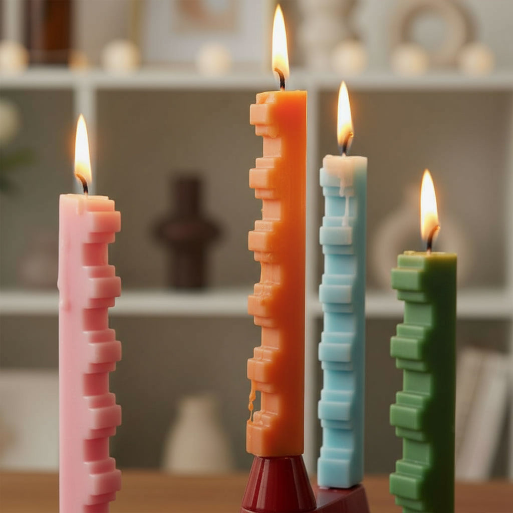 Modern stair-step taper candles burning—geometric sculptural tapers for home décor and DIY candle making, pink orange blue green - Boowan Nicole