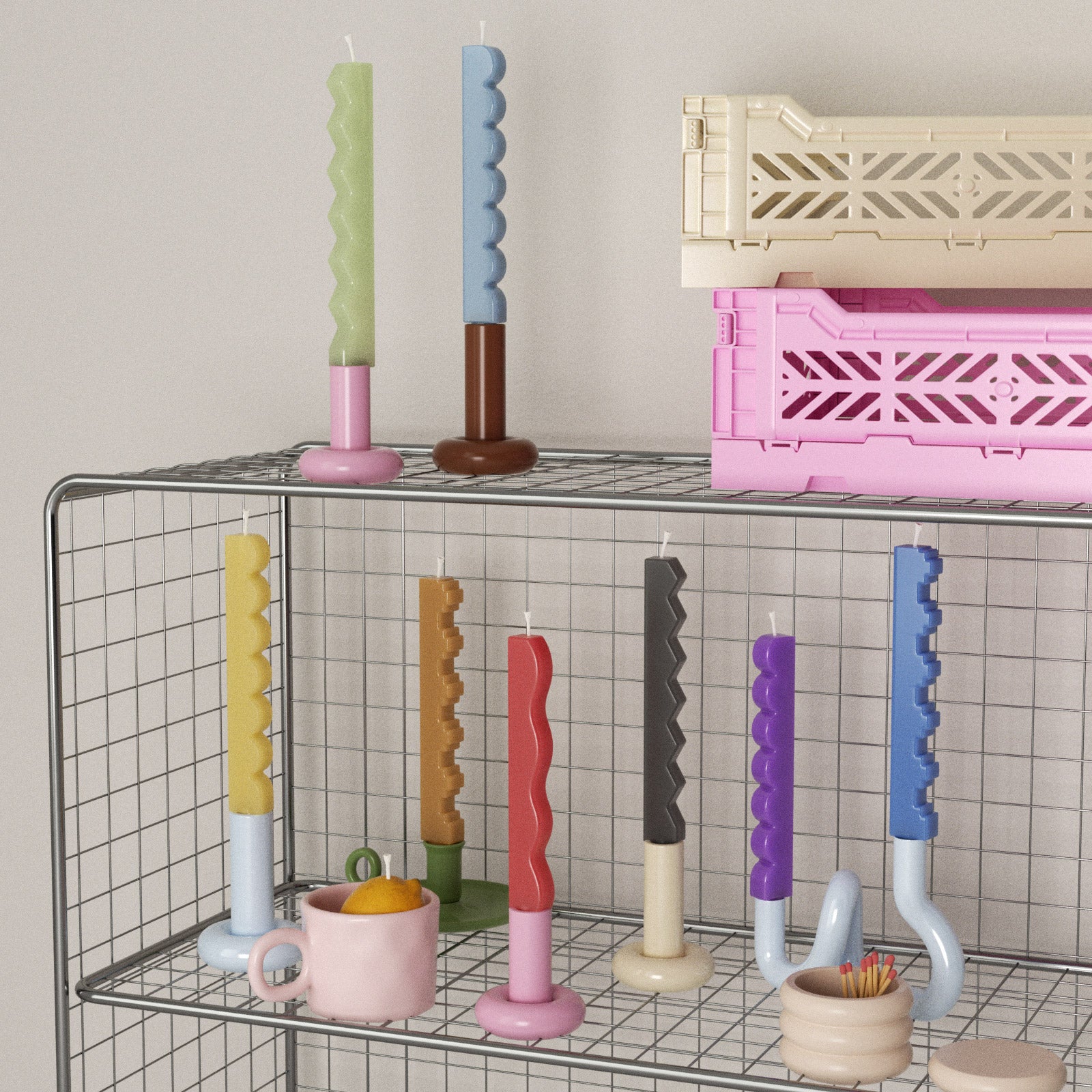 Colorful zigzag and stair-step taper candles on a wire shelf with pastel holders - Boowan Nicole