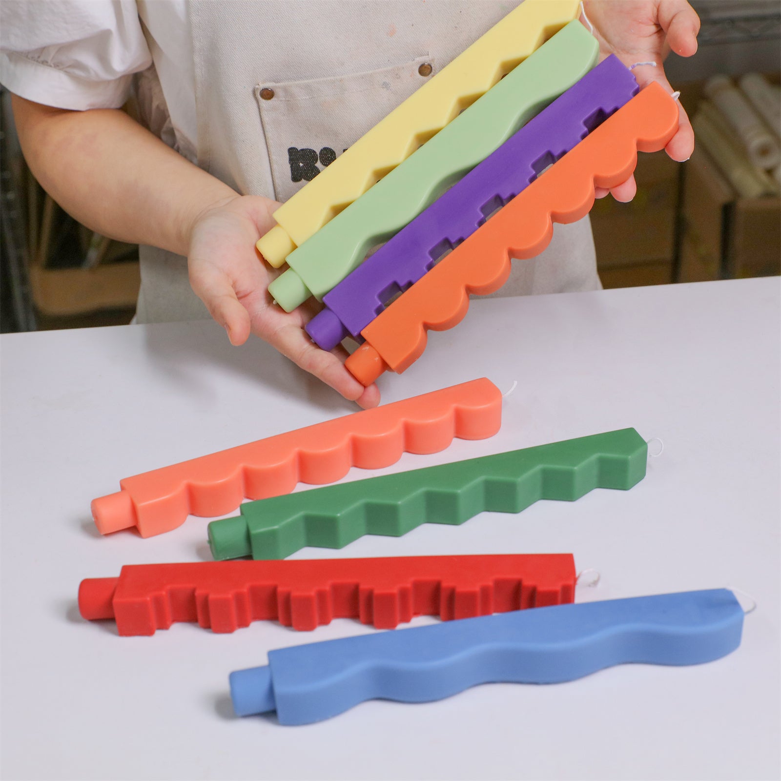 Hands holding stacked zigzag taper candles - Boowan Nicole