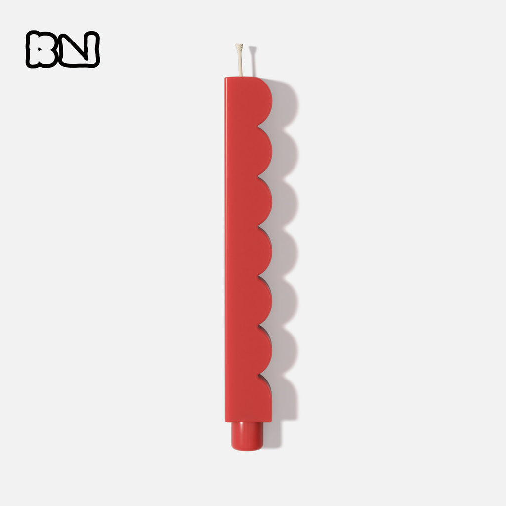 Red wave taper candle on white background