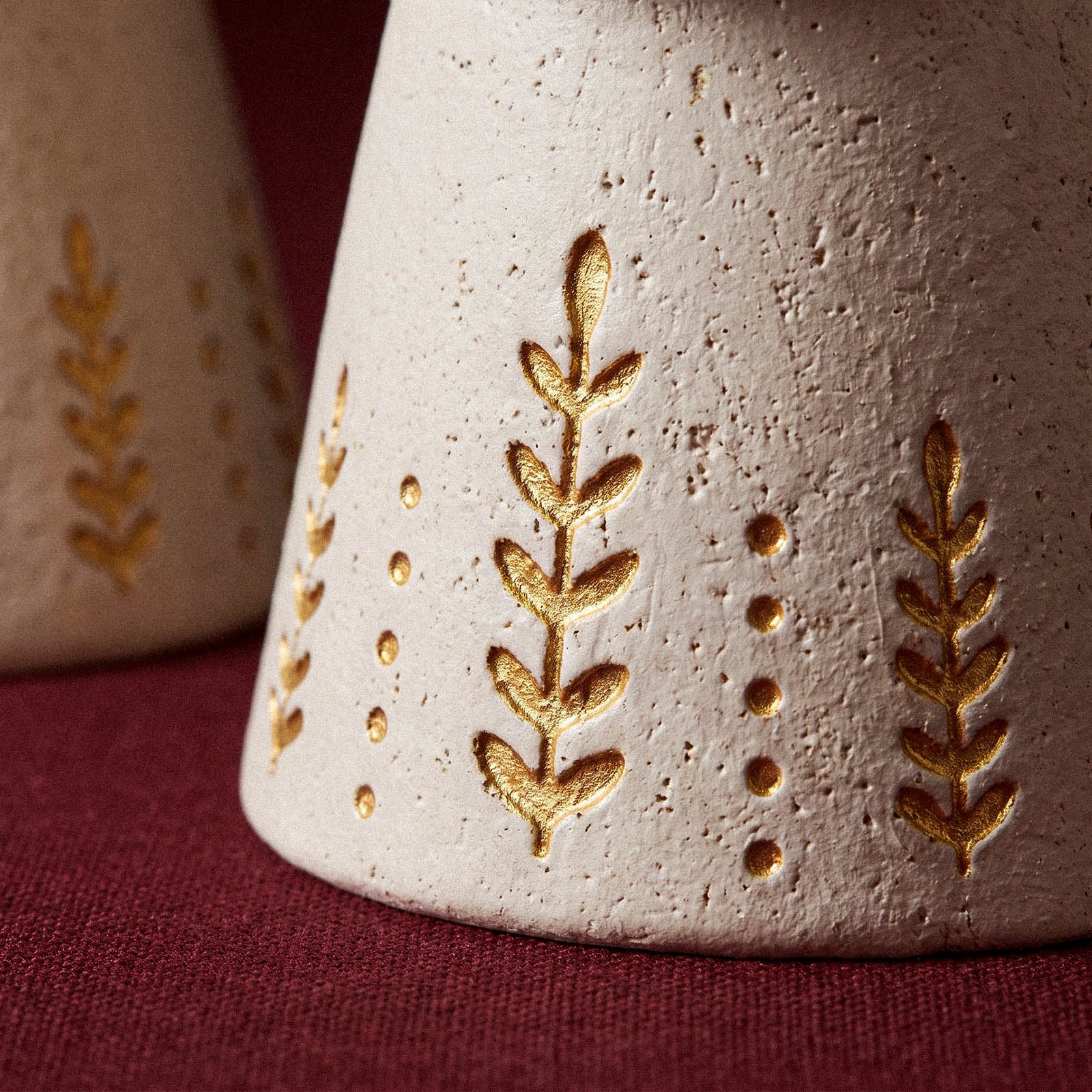 Close-up of the gold leaf and dot embossed pattern on the Angel of Light Tealight Holder mold skirt