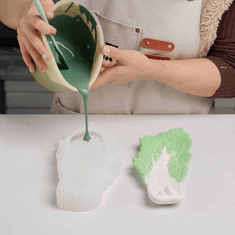 Pouring green casting mixture into a cabbage leaf silicone mold