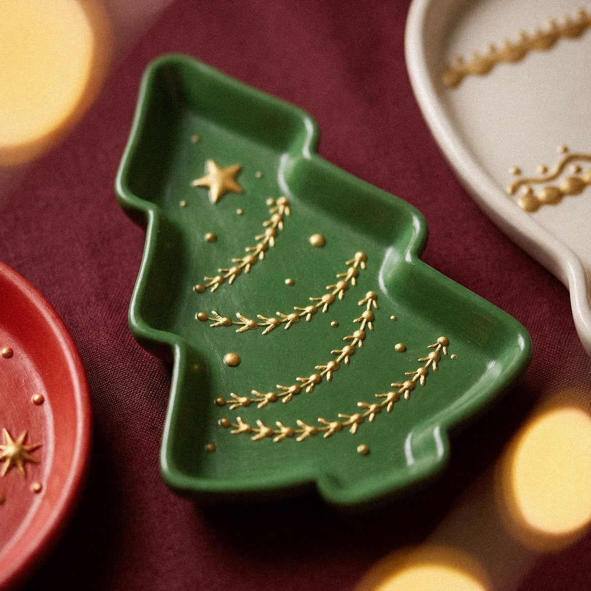 Close-up of a green Christmas tree tray with gold star and garland relief details