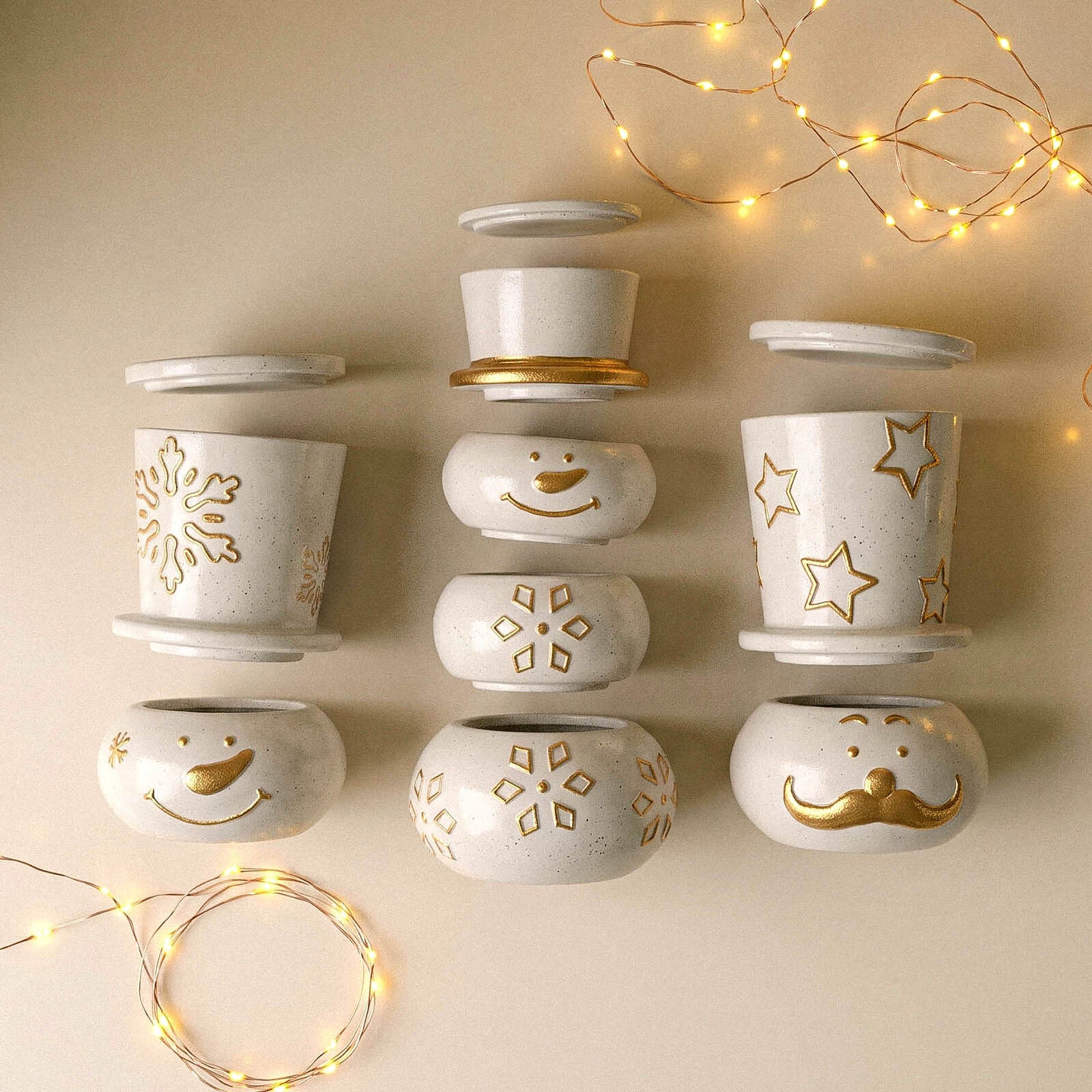Snowman candle jars displayed with warm string lights