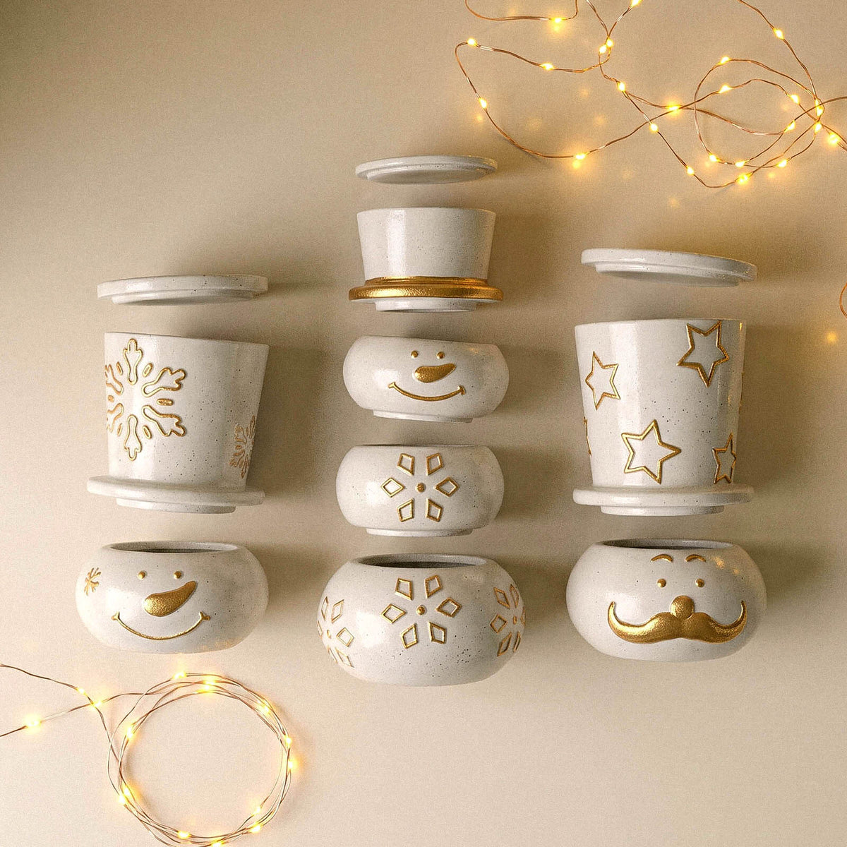 Snowman candle jars displayed with warm string lights