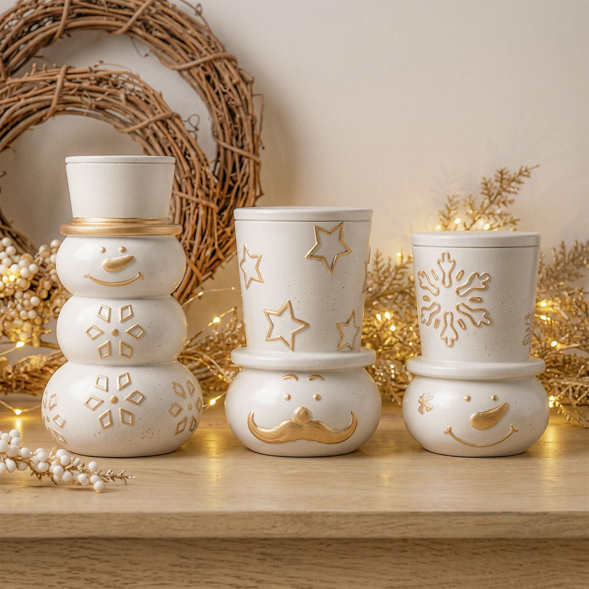 Three stacked snowman candle jars with gold stars, snowflakes and moustaches