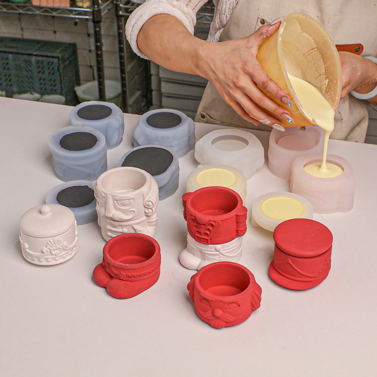 Demolding cream nutcracker jar sections from the silicone molds