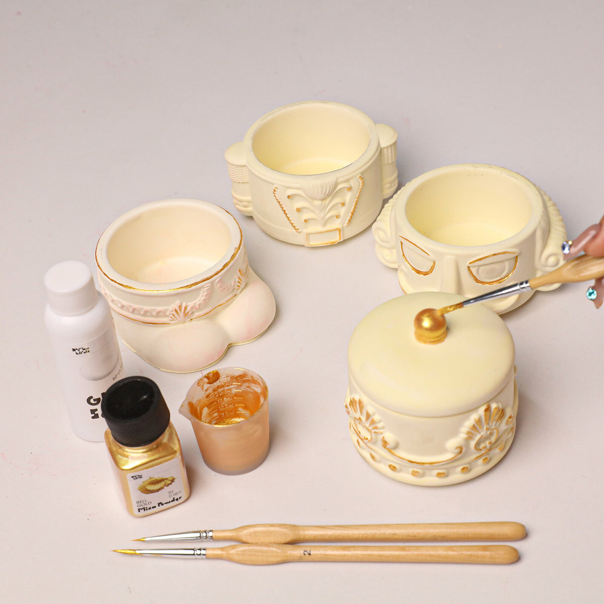 Adding gold mica powder to paint nutcracker jar details