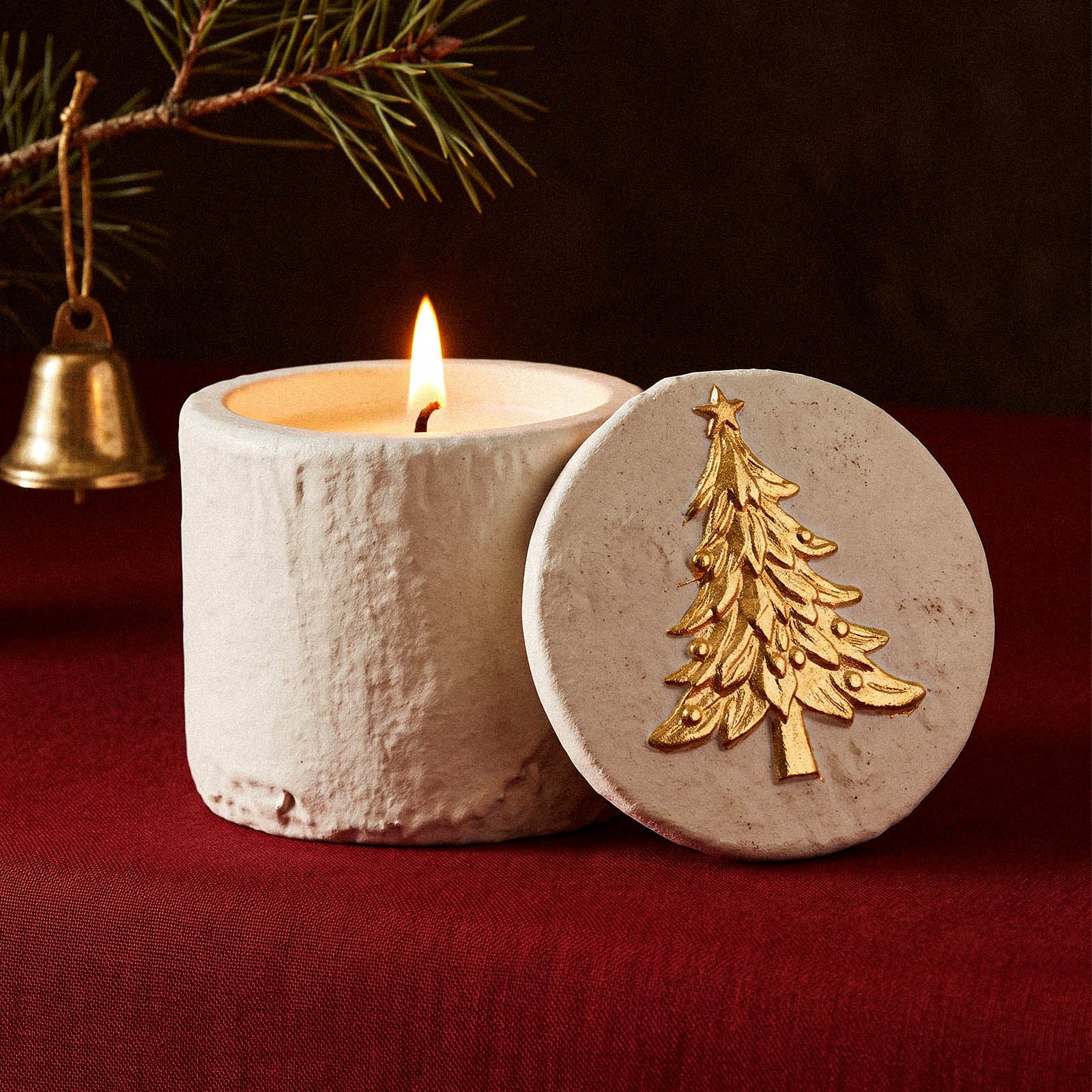 Lit candle in Cozy Christmas Candle Jar with tree emblem lid