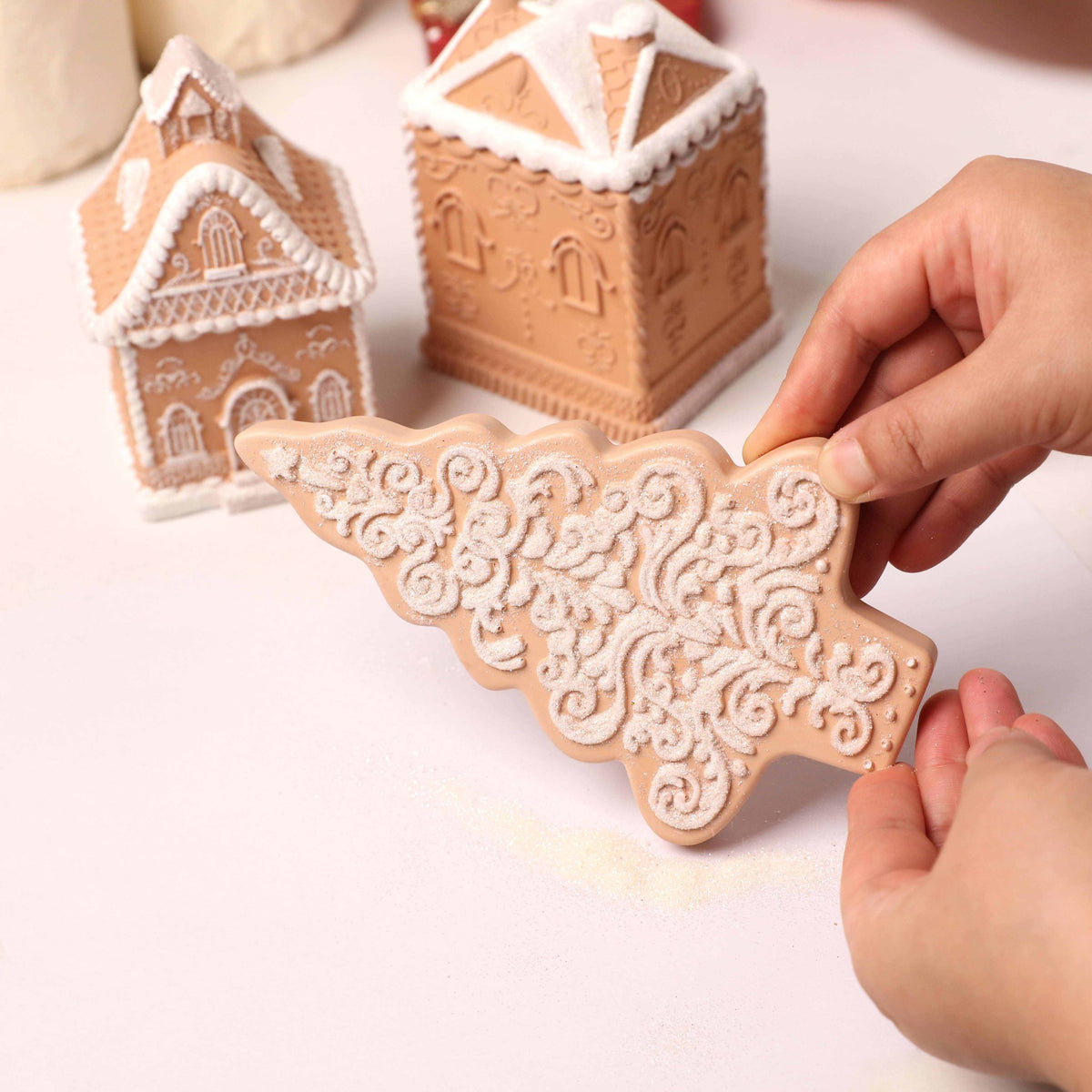Glitter-accented gingerbread house and Christmas tree castings