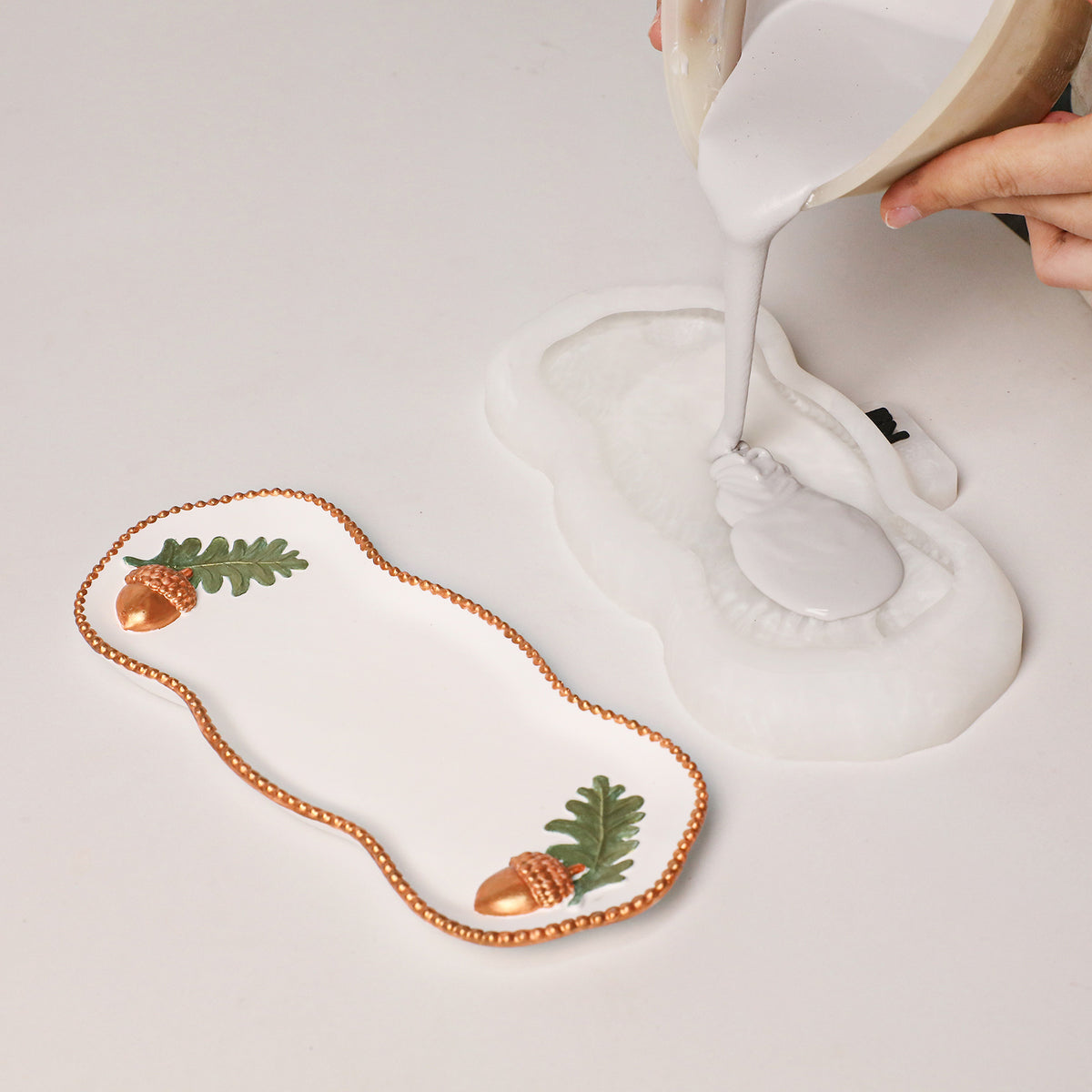 Pouring resin into the Forest Acorn Tray Silicone Mold
