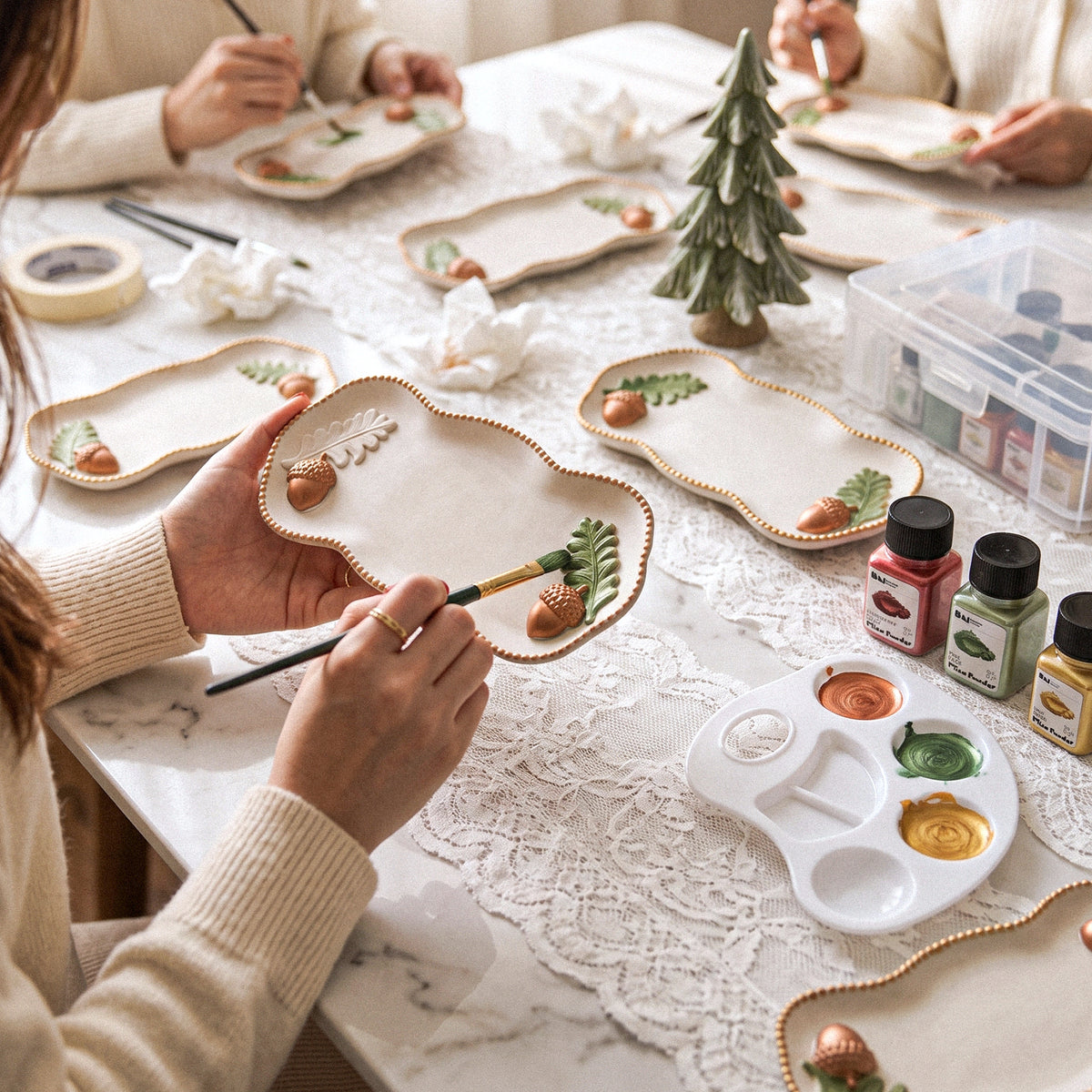 Crafters pouring the Forest Acorn Tray Silicone Mold together at a workshop table