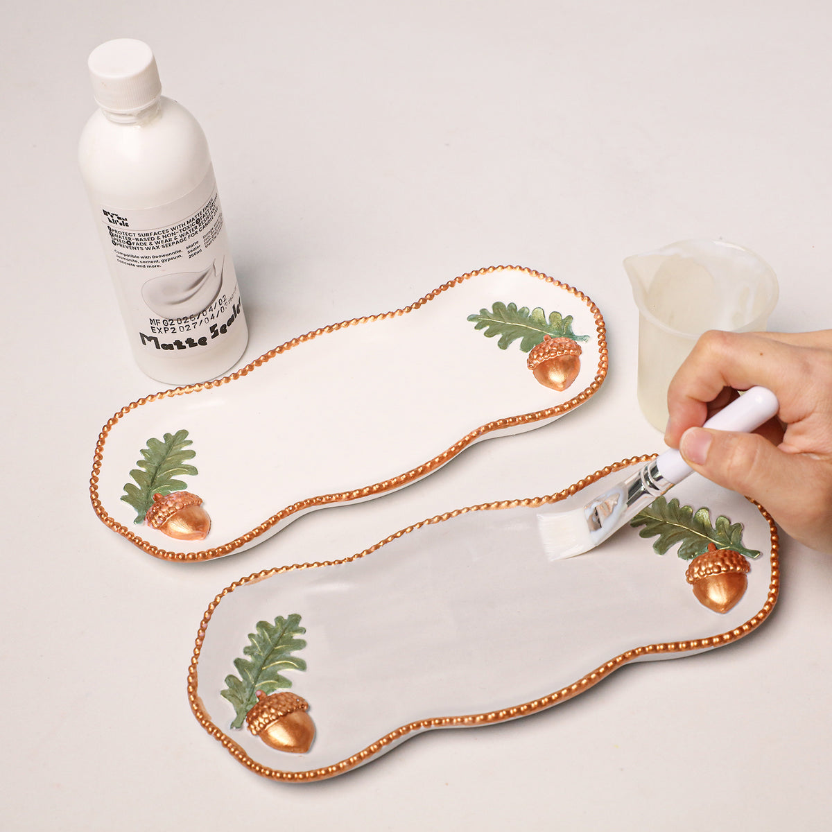 Finished Forest Acorn tray next to a bottle of gloss sealer