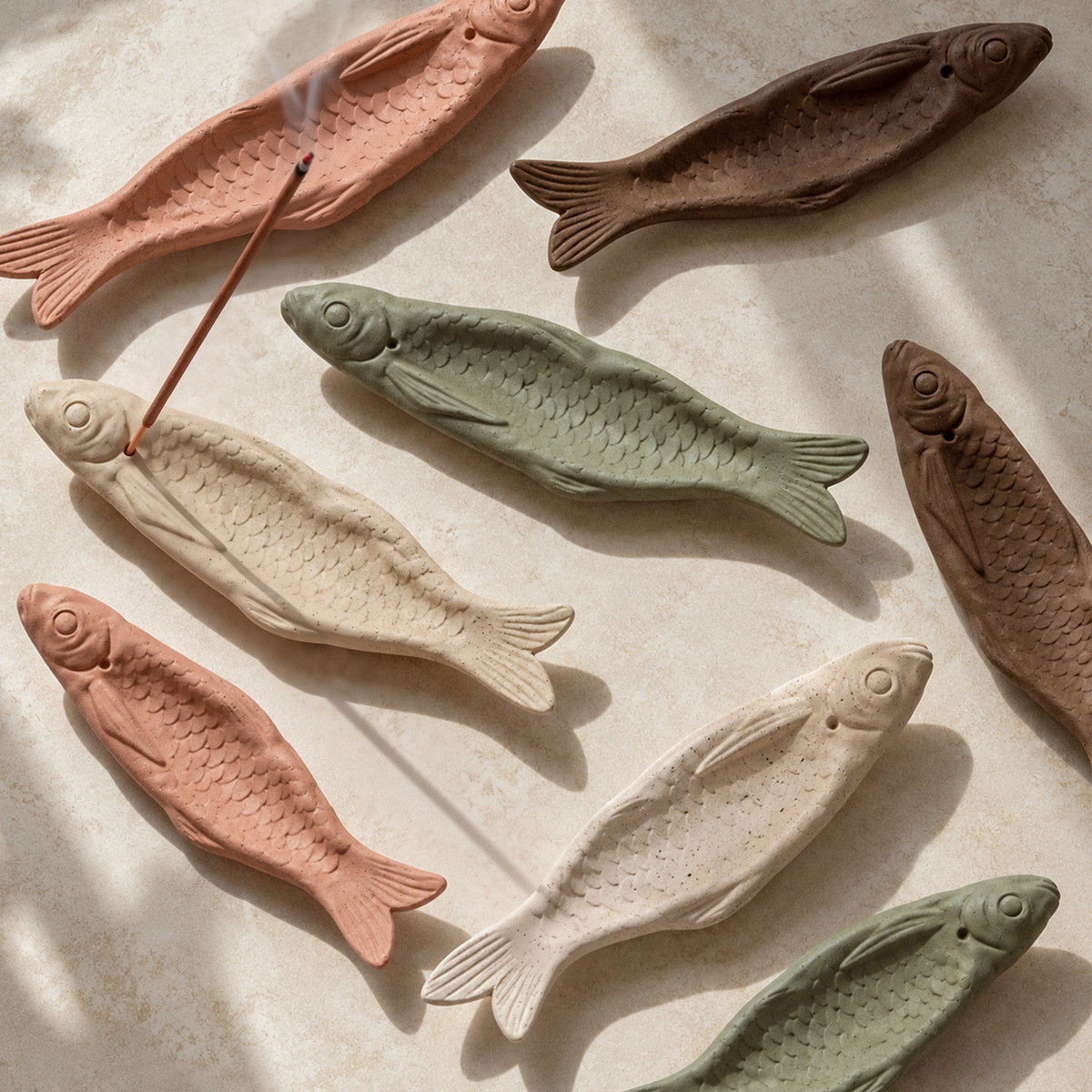Fish incense holders in natural, green, terracotta and brown finishes