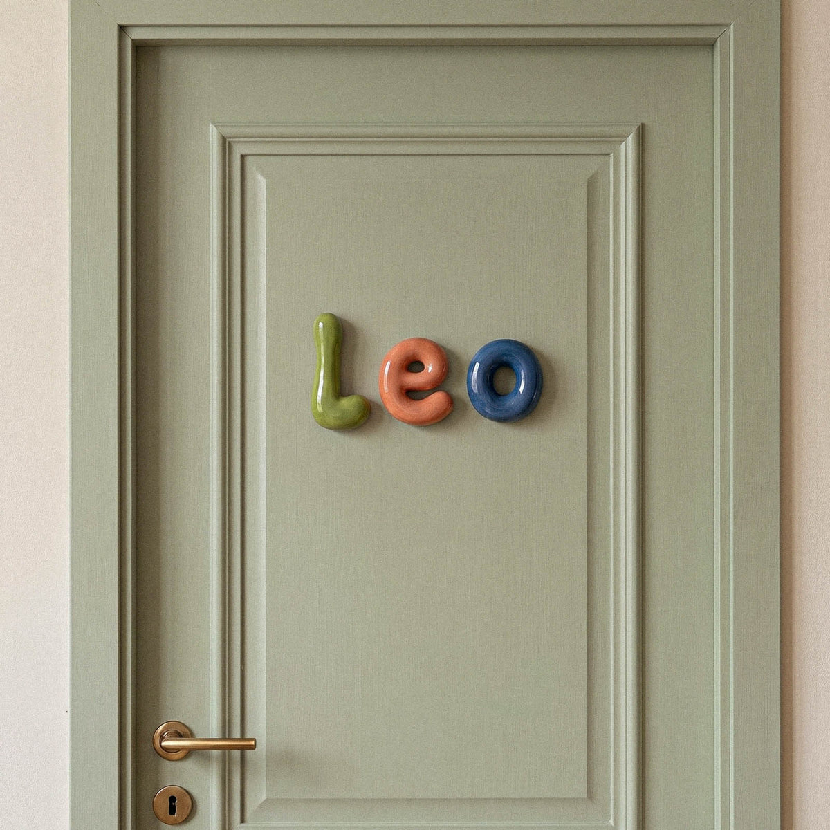 Lowercase letters spelling leo on a green door