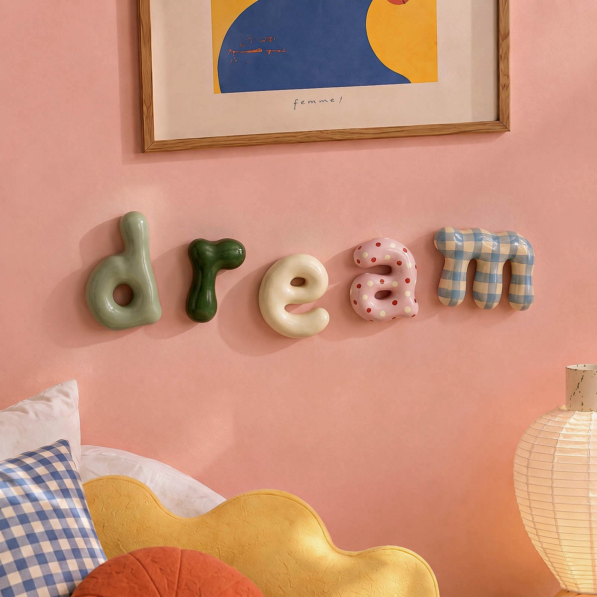 Decorative lowercase letters spelling dream on a pink wall