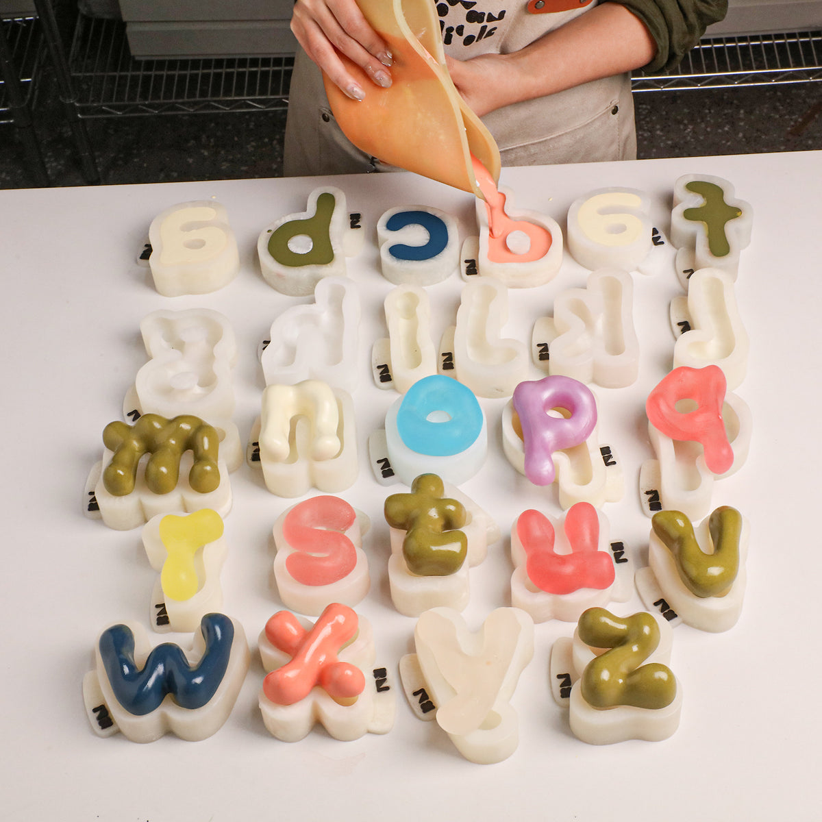 Casting mixture poured into individual letter molds