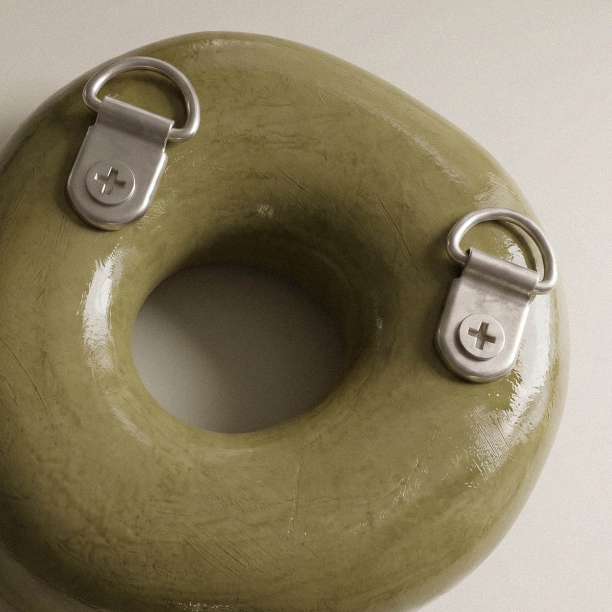 Back of a cast letter with two metal hanging loops