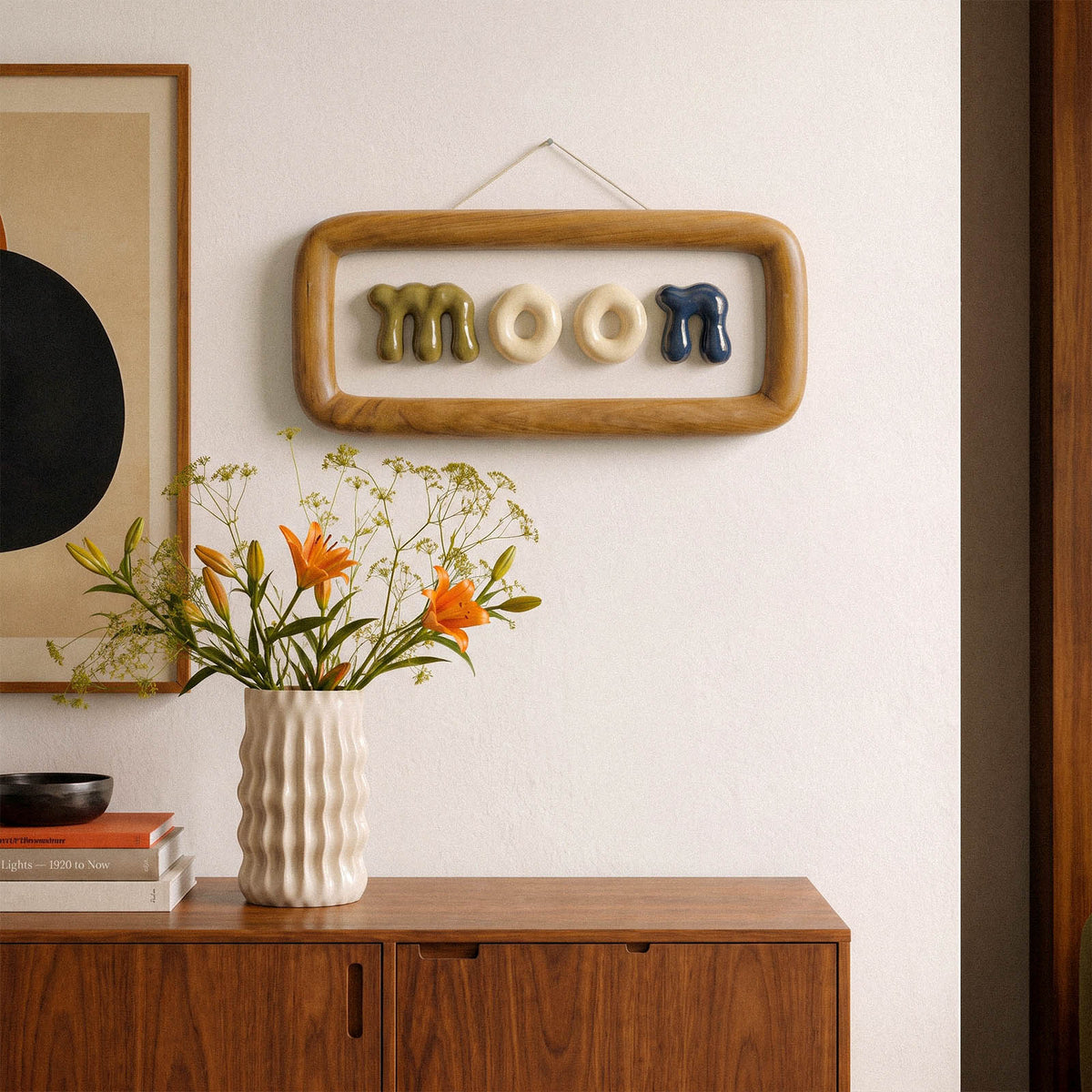Lowercase letters spelling moon displayed in a framed wall arrangement