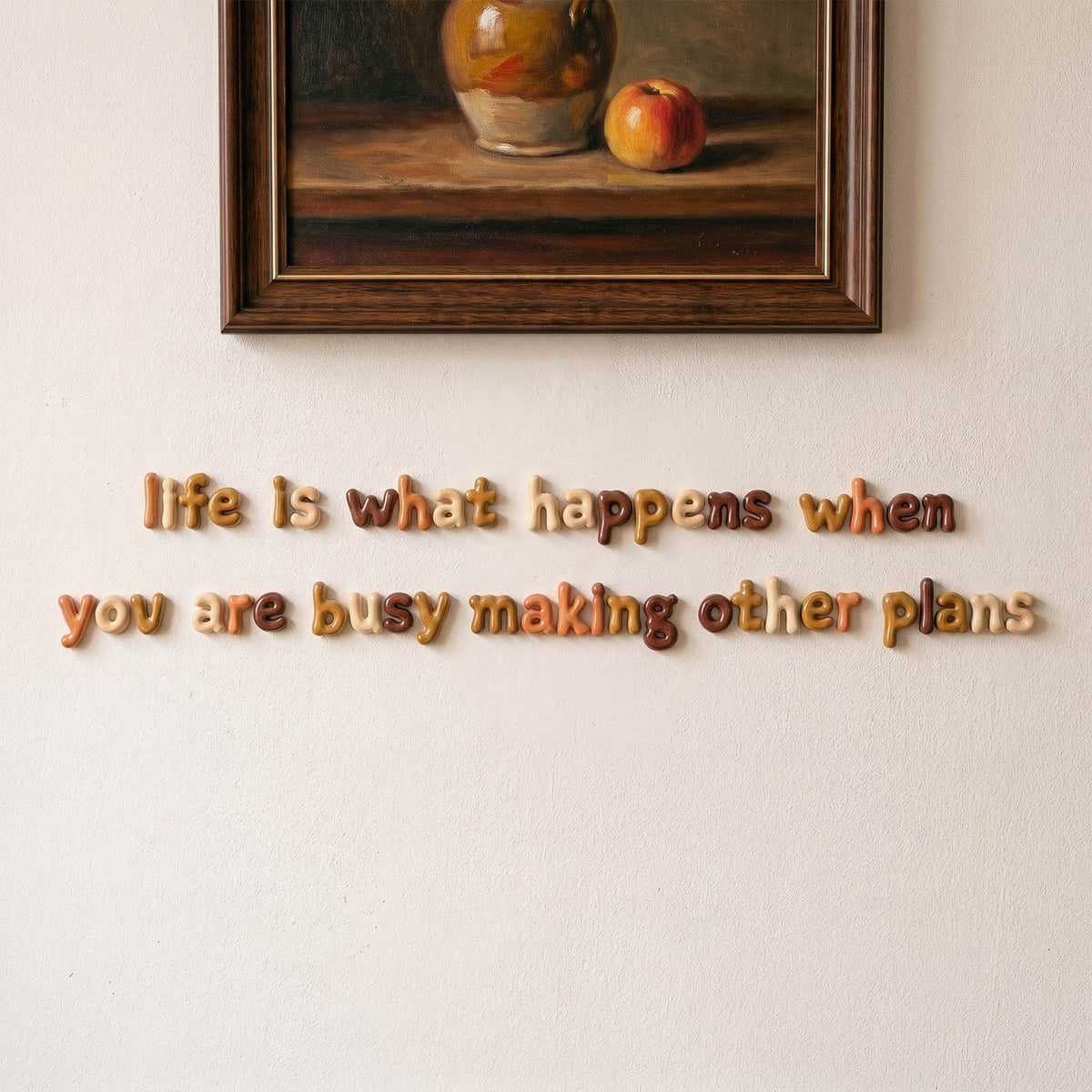 A decorative sentence made from small rounded lowercase letters on a wall