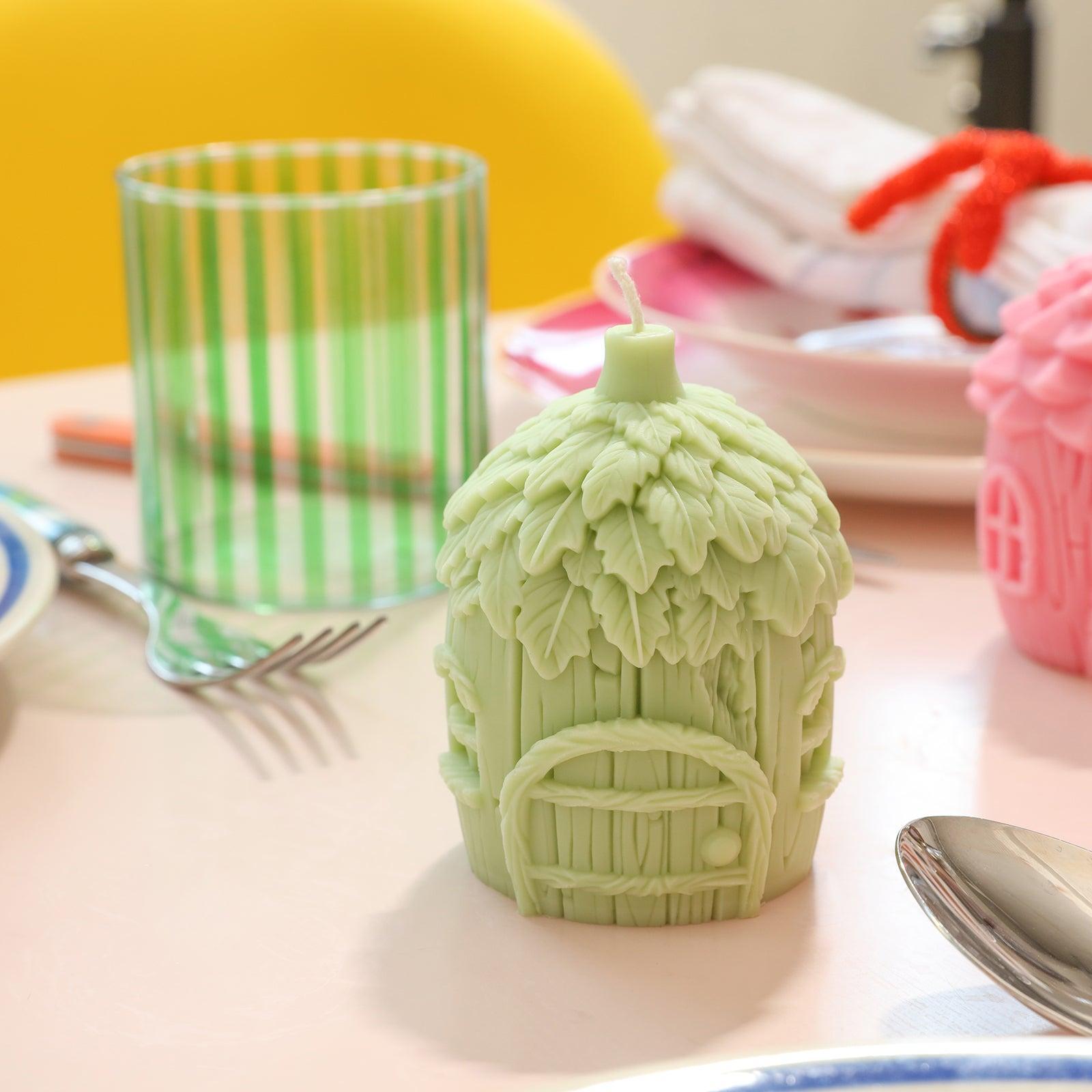 Green miniature fairy house candles placed on the dining table - Boowan Nicole