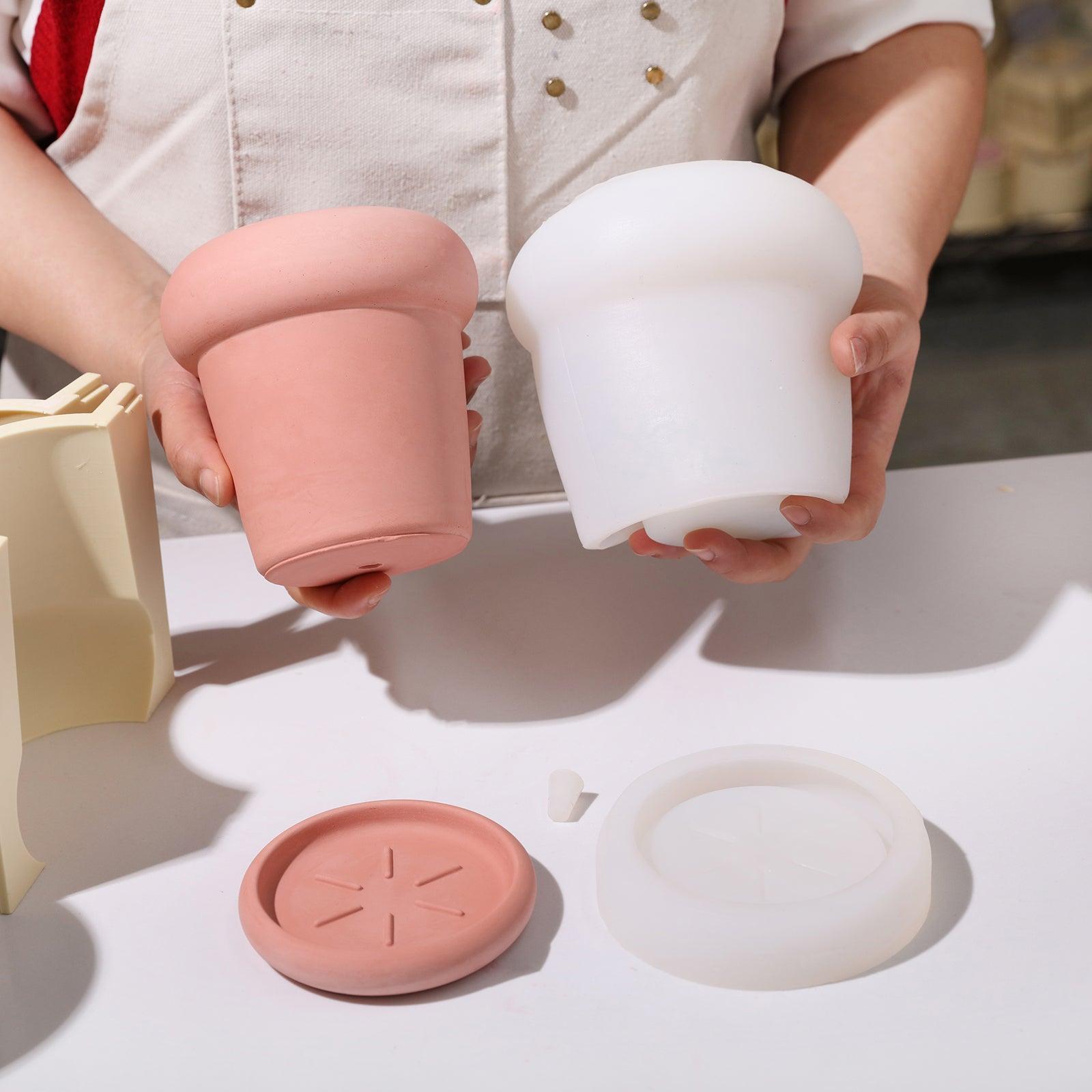 Hand-held display of reddish brown Tall Botanic Column Plant Pot and white silicone mold - Boowan Nicole