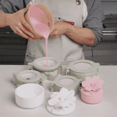 Animation of pouring pink cement into the hibiscus candle jar silicone molds