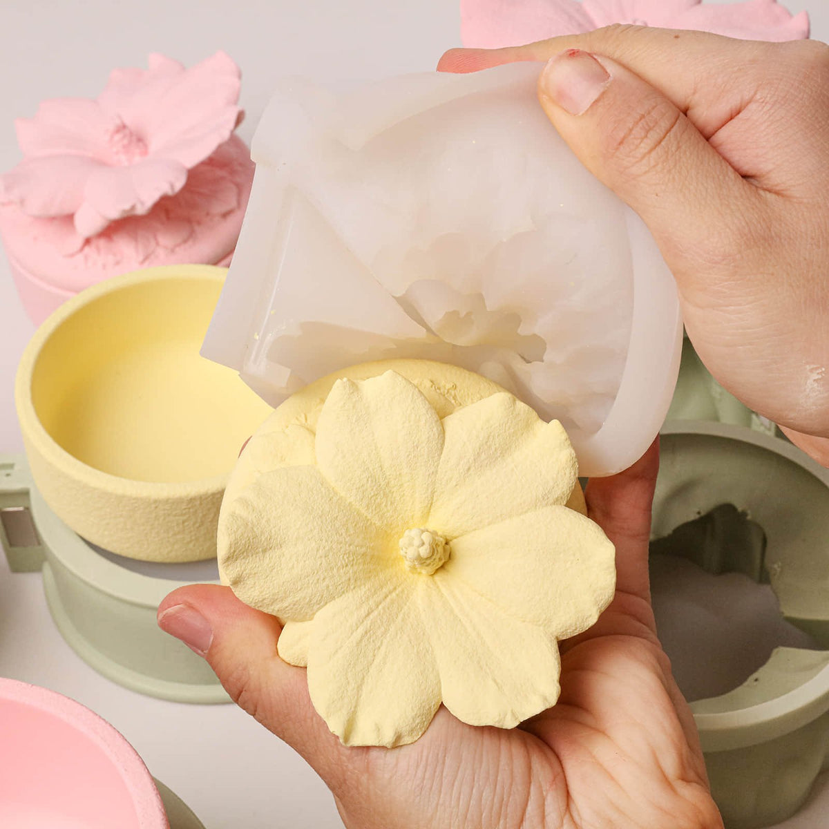 Demolding a yellow hibiscus lid from the silicone mold