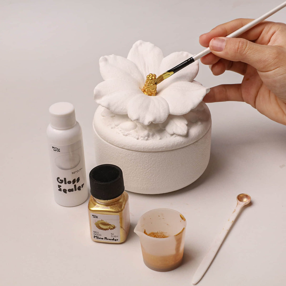 Painting the hibiscus stamen with gold mica powder