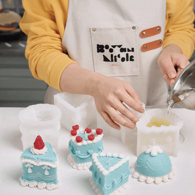 Pouring candle wax into cake-shaped silicone molds