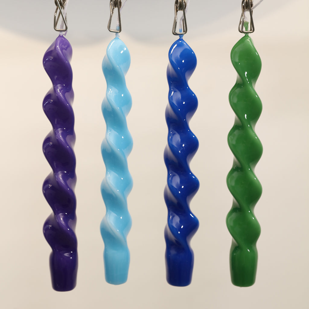 Four Spiral Taper Candles in green, green, blue and purple hanging on the shelf with clips-Boowan Nicole
