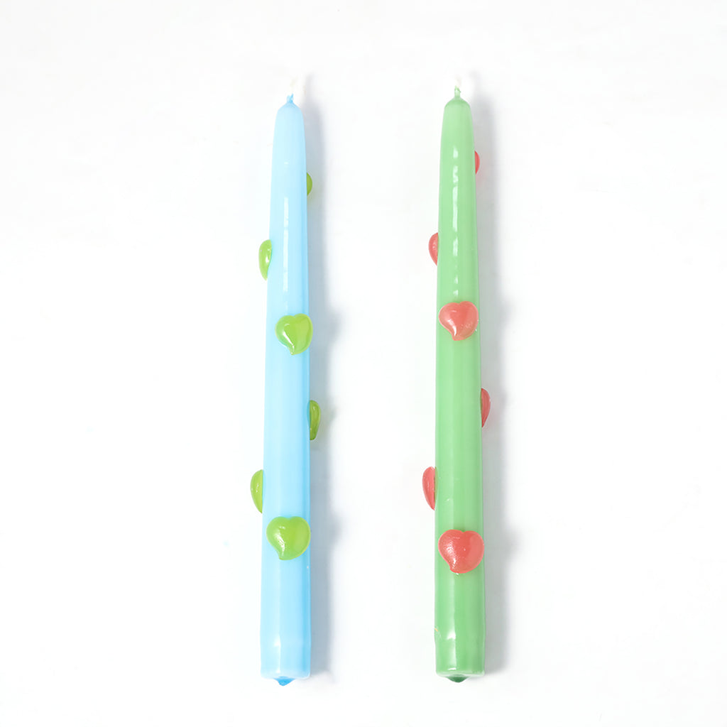 One blue taper candle with green heart accents and one green taper candle with red heart accents-Boowan Nicole