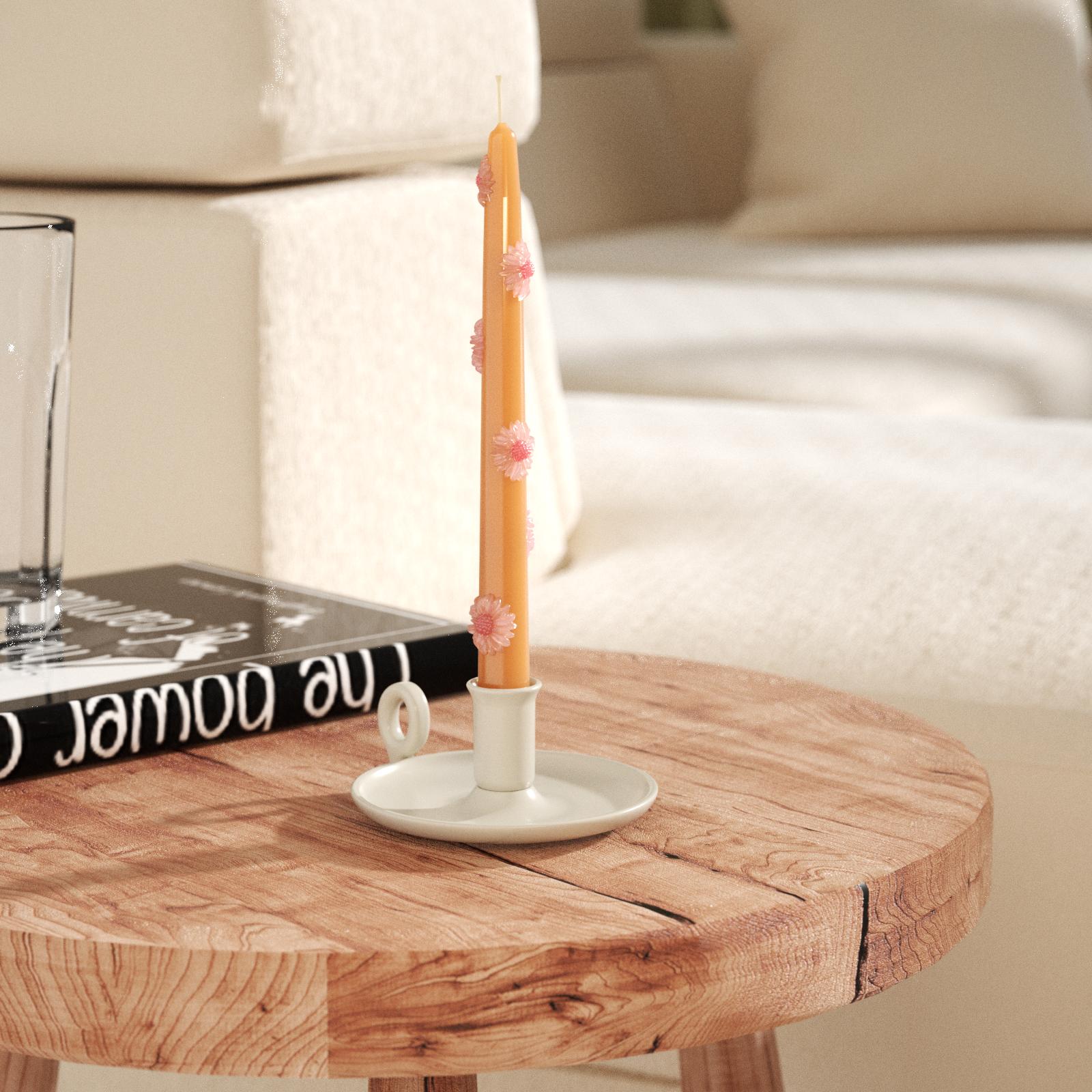 Yellow-brown daisy taper candles on white candlesticks on tabletop-Boowan Nicole