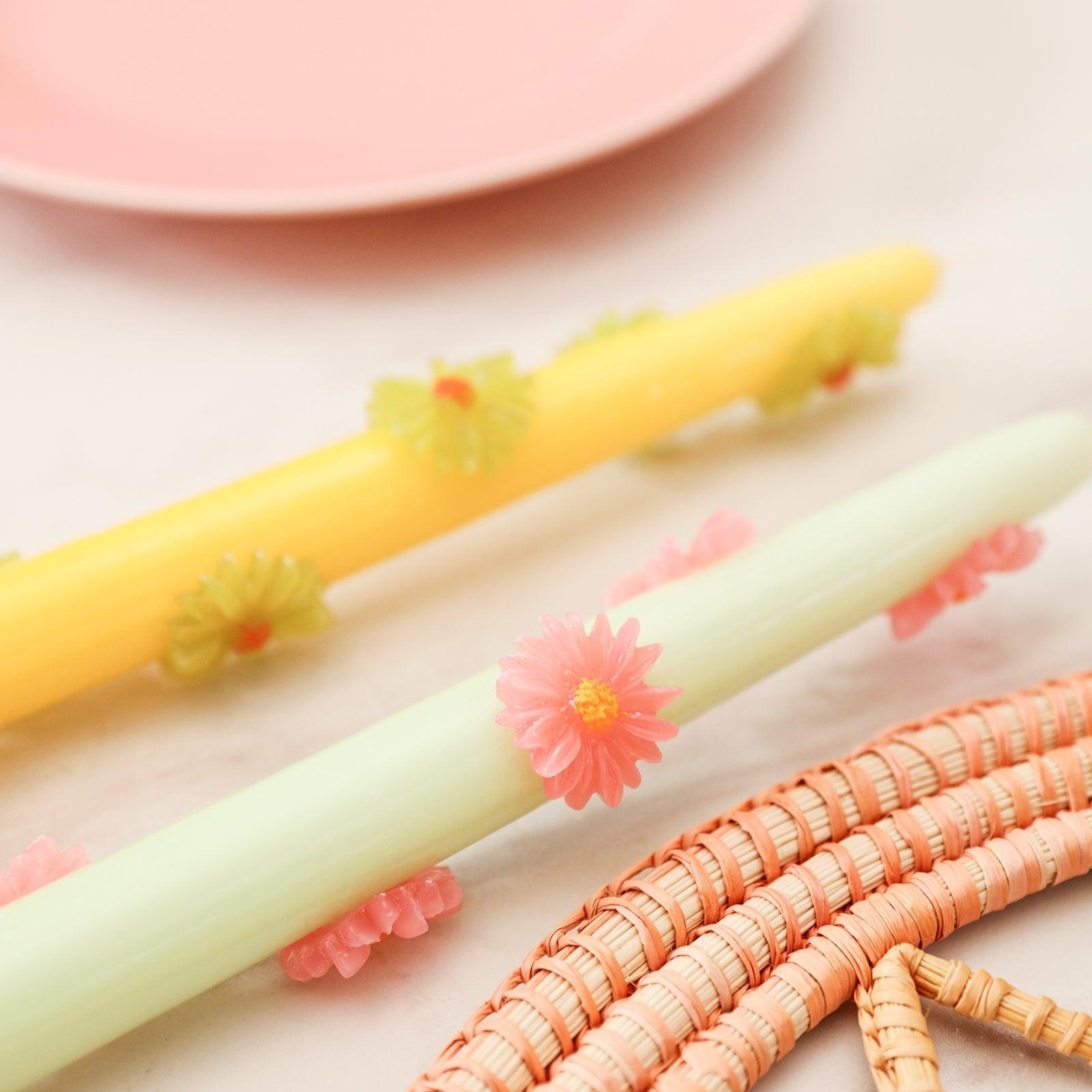 Yellow daisy decorative tapered candles placed on the table - Boowan Nicole